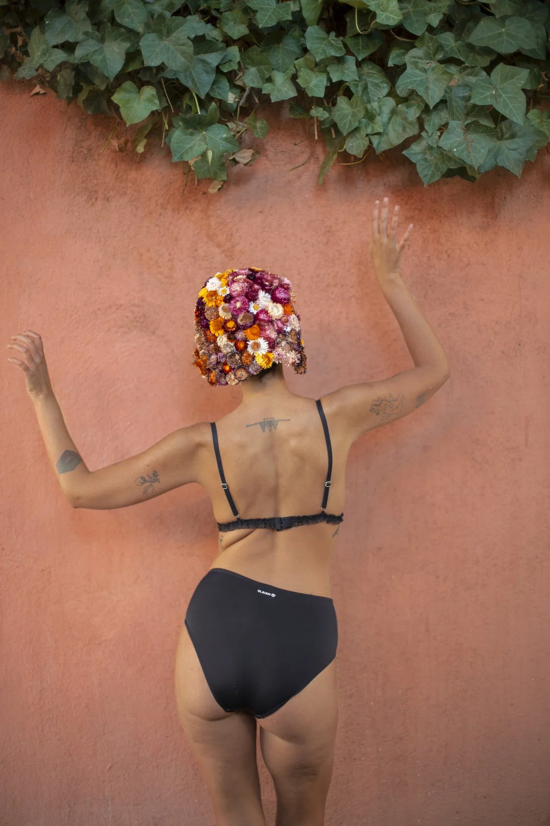 Editorial bathing suit look with floral styling by Mosaic Flowers in colorful streets of Gracia Barcelona