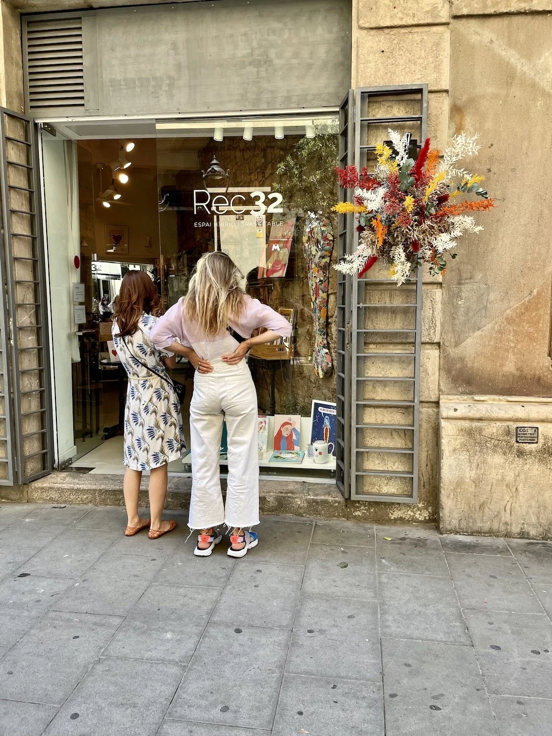 Visitors admiring Mosaic’s floating floral installation outside art gallery in Barcelona
