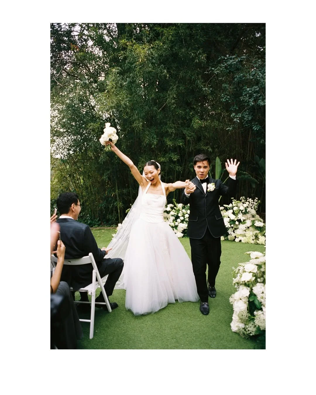 Elegant portrait of Christie and Andrew framed by bespoke floral creations at Villa Almanita, a luxury masia in Catalunya