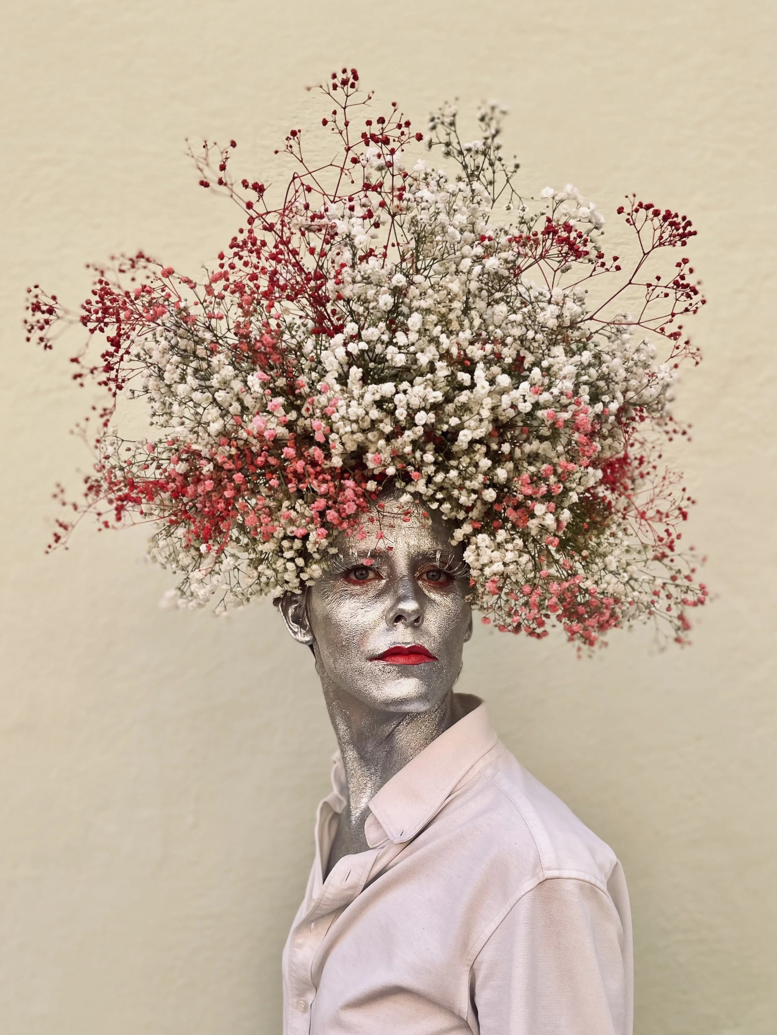 Margaux wearing a gypsophila crown, painted in silver, captured in an artistic floral portrait in Barcelona.