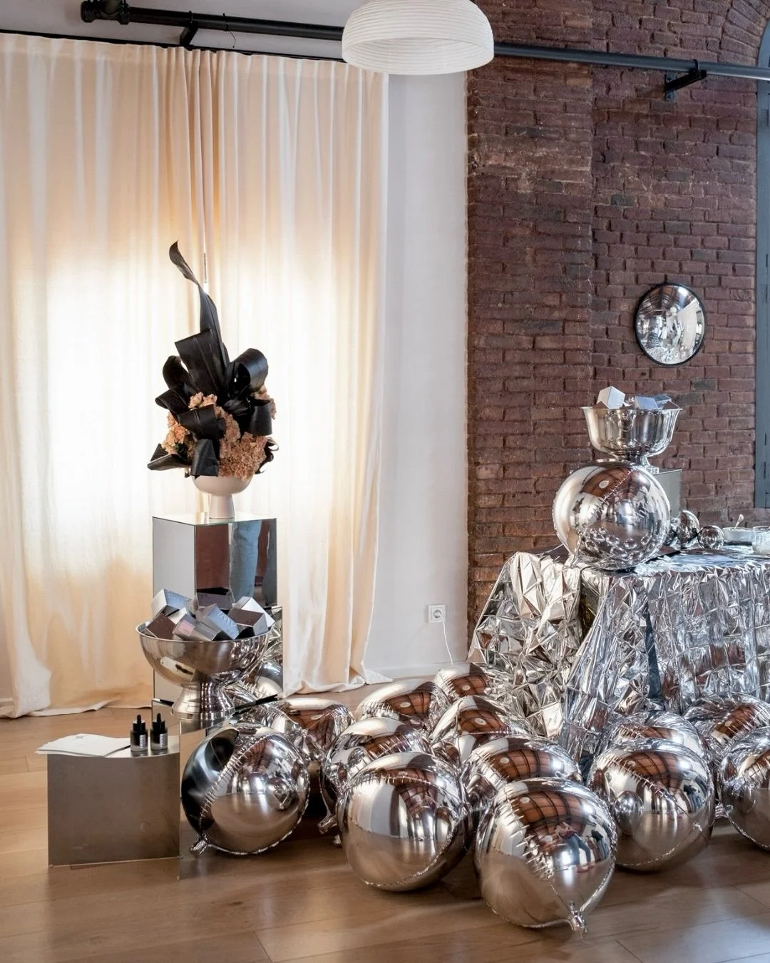 Luxury event space at Juno House Barcelona featuring a sculptural botanical installation made with black Cordyline leaves for the FAWE PR event by A Point Agency