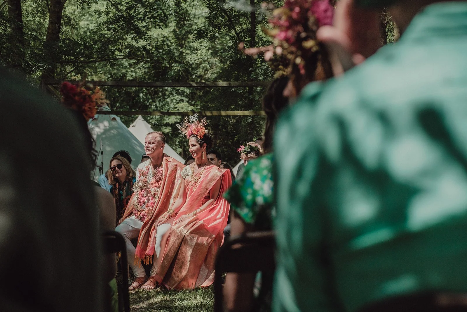 Original wedding ceremony in the forest where Mosaic created bold floral crowns and necklaces with preserved flowers
