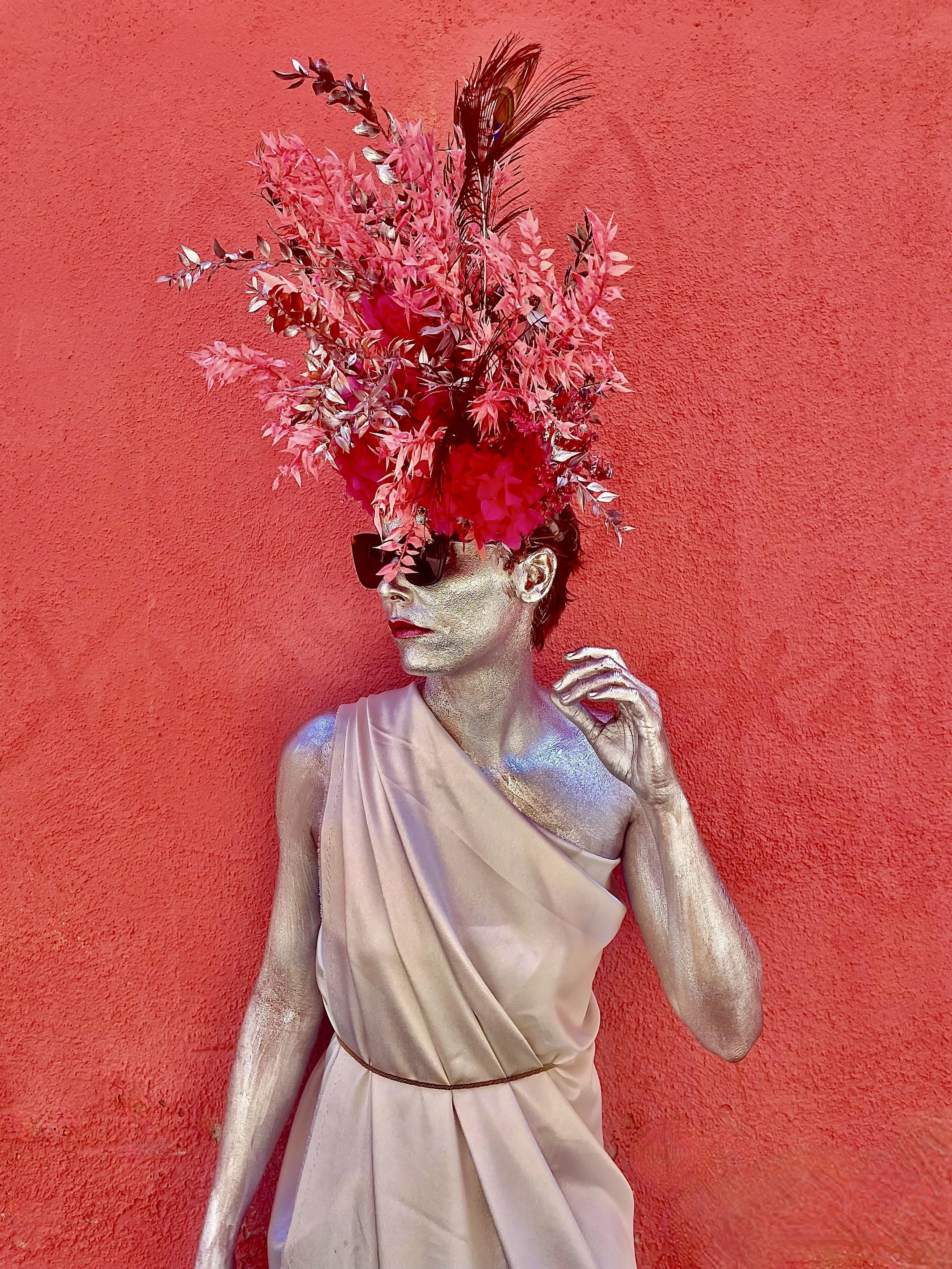 Margaux wearing an explosive floral crown of painted preserved flowers, styled as a cosmic goddess in Barcelona