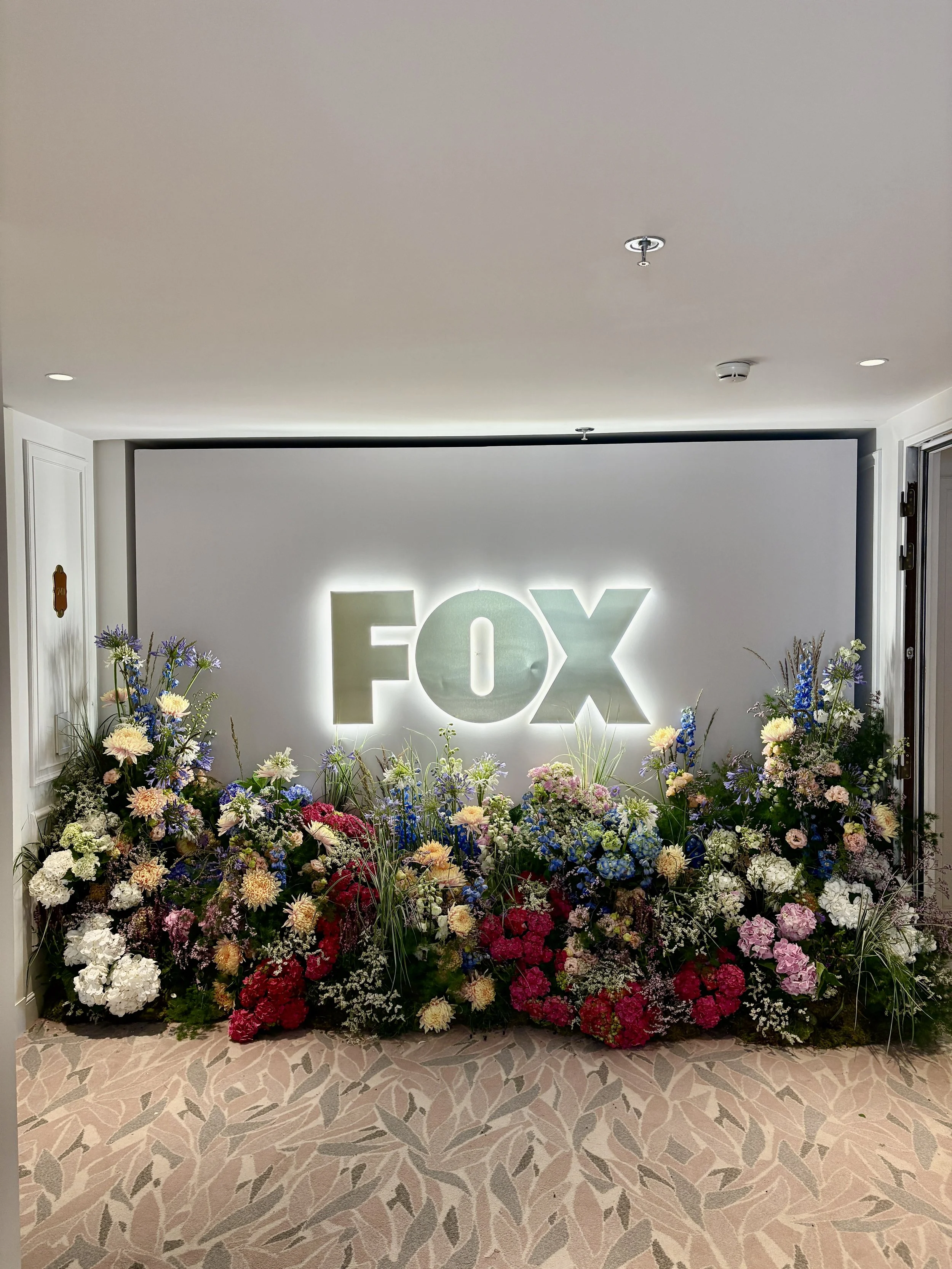 Bespoke floral backdrop and luxury flower installations created for the FOX VIP event at the Ritz-Carlton Suite, combining high-end blooms with contemporary event design