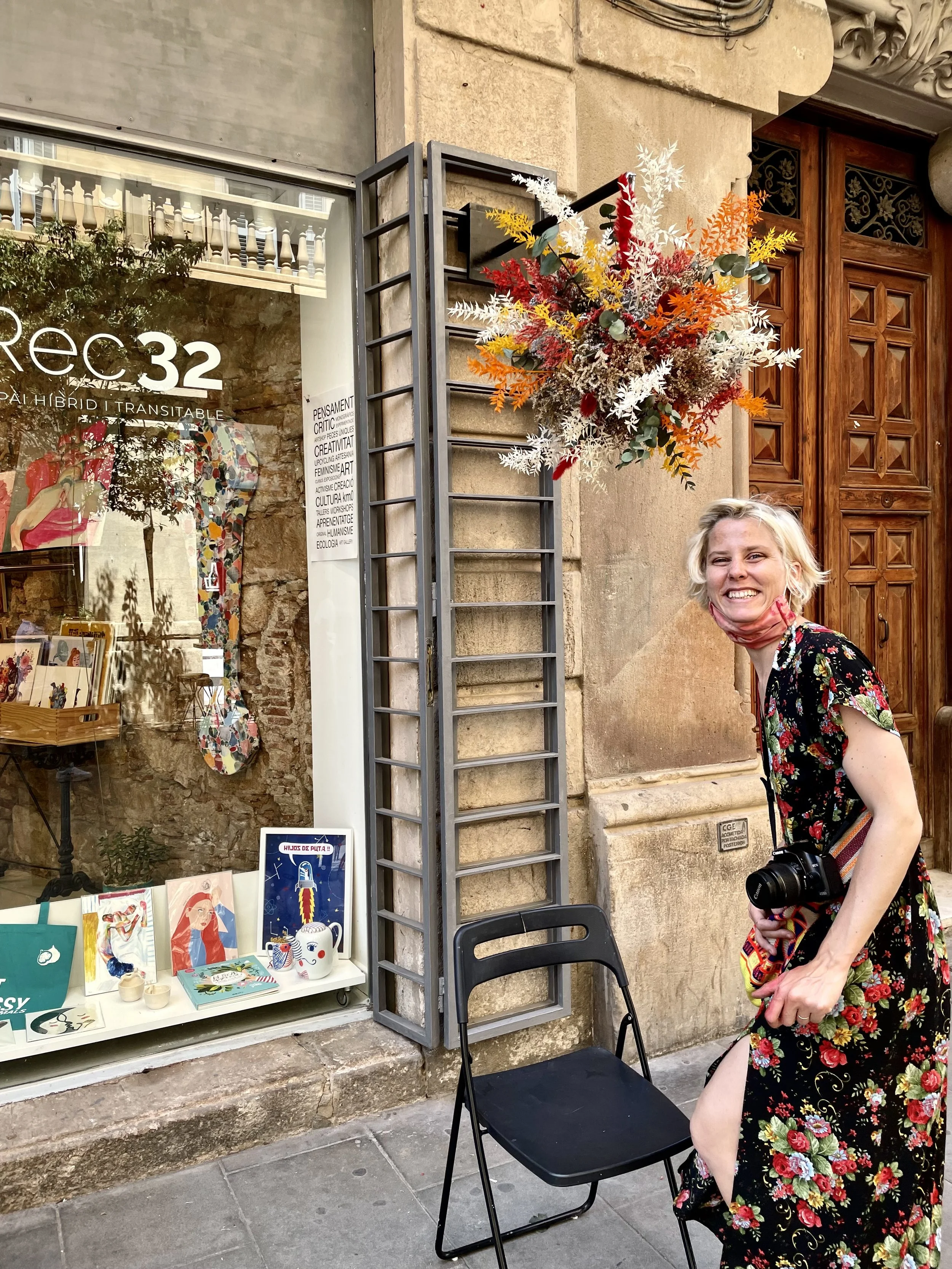 Floral artist Margaux presenting artistic floating flower sculpture outside L’Explo gallery Barcelona