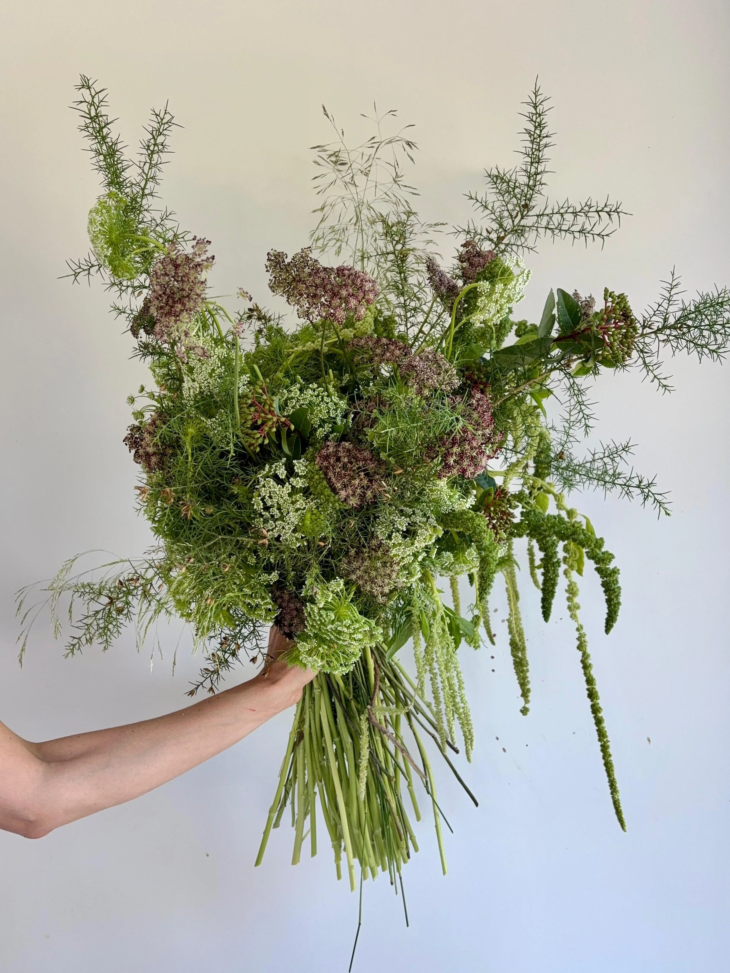 Bespoke luxury floral bouquet created for VIP gifting in Barcelona, featuring an artistic mix of seasonal greenery and textured flowers for exclusive luxury events and international brands