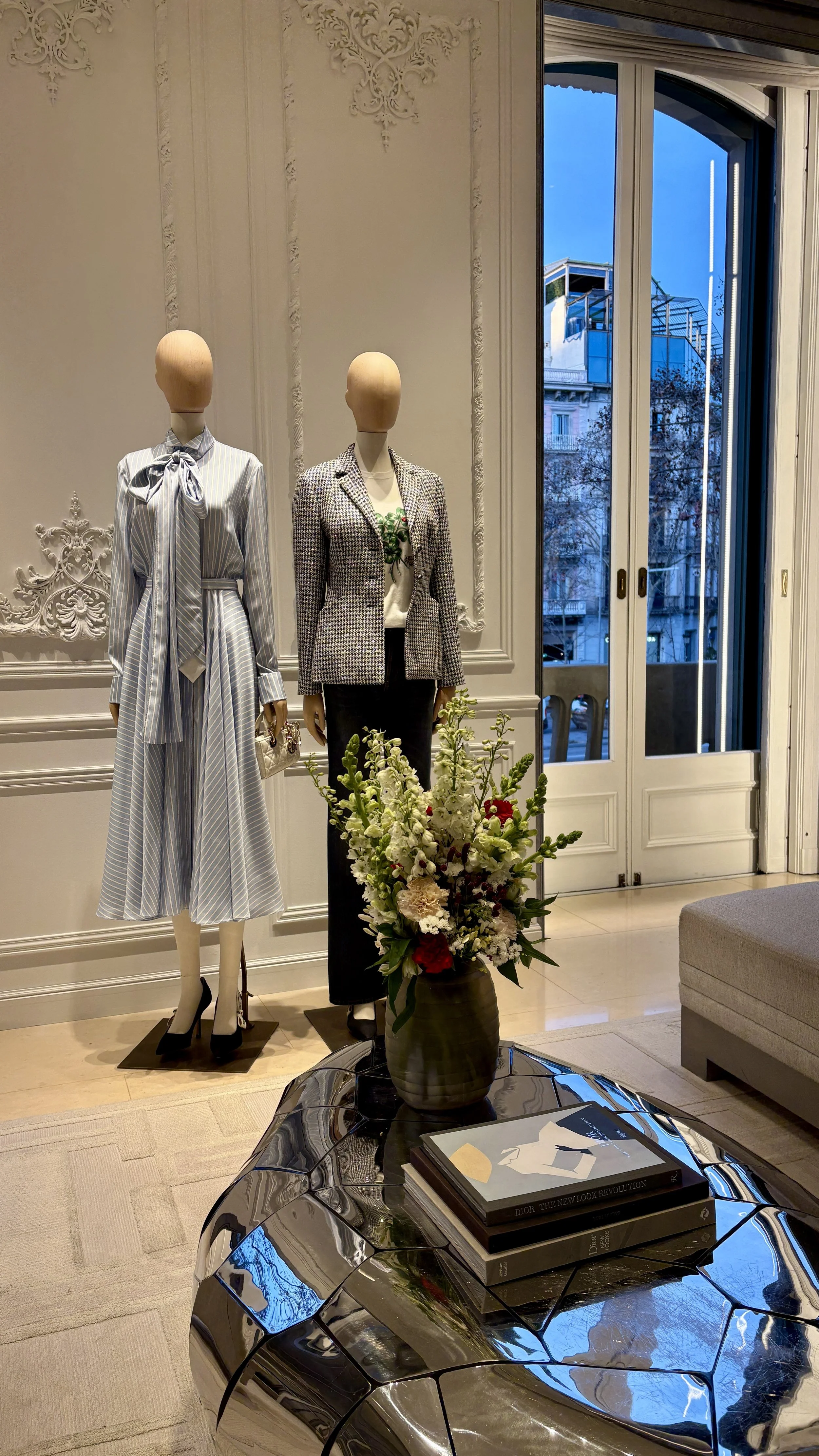 Seasonal luxury floral arrangement on a designer reception desk inside a Barcelona flagship fashion store