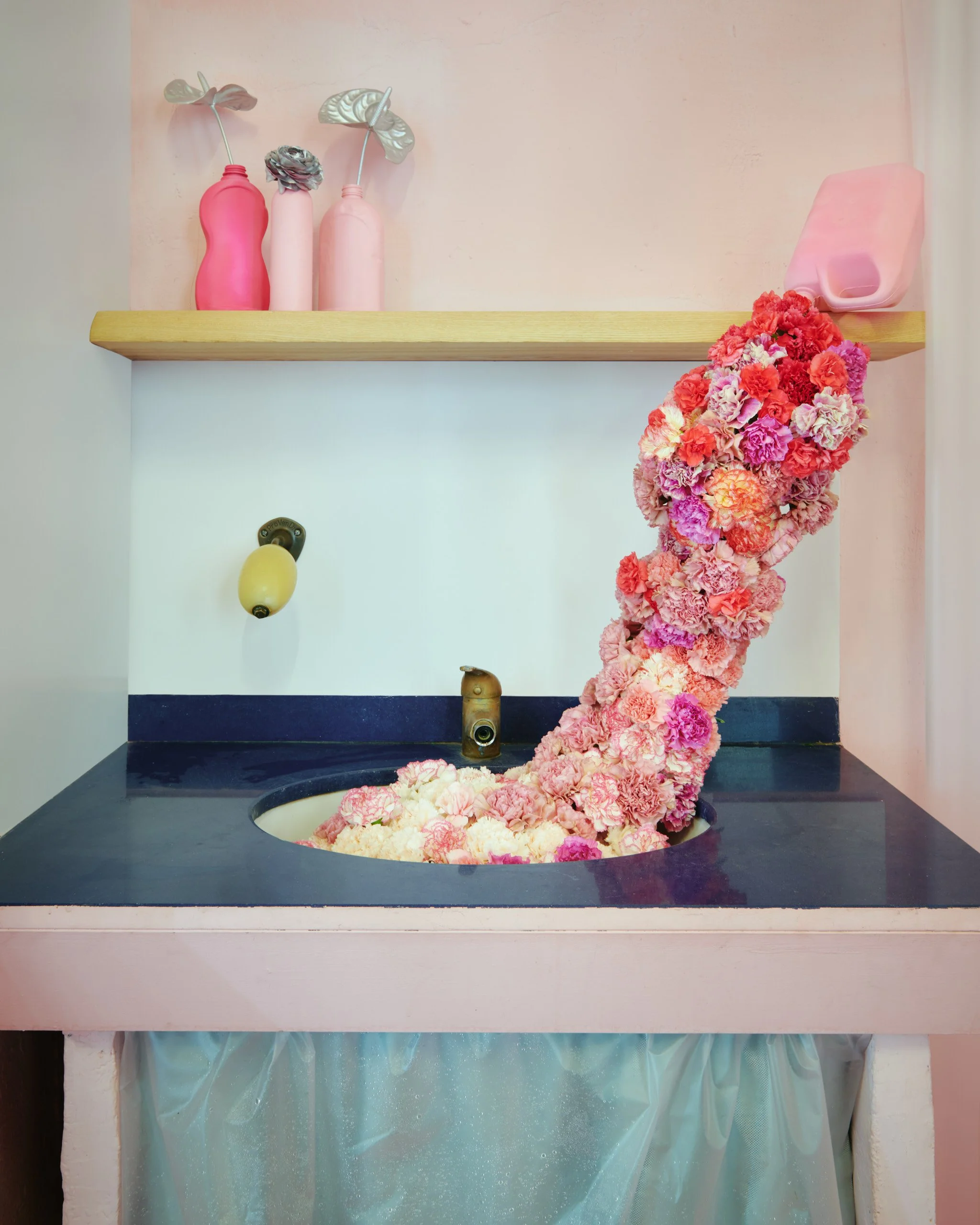 Bottle spilling flowers as a sculptural installation by Mosaic for The Bathroom exhibition in Barcelona