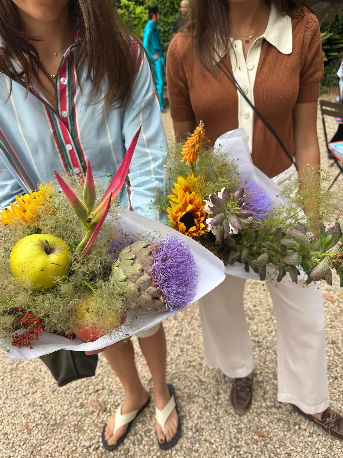 Guest holding a bouquet while attending the La Veste × Ivine Paris launch event, surrounded by bespoke floral styling and luxury botanical décor
