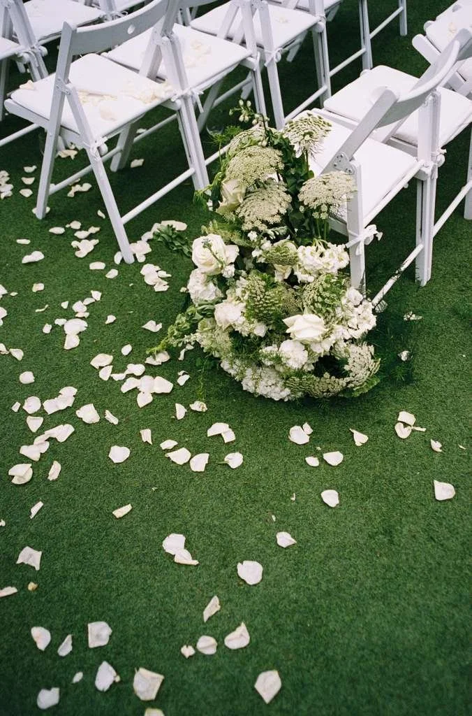Elegant floral centrepiece featuring layered seasonal flowers and refined botanical design for Christie and Andrew's wedding reception