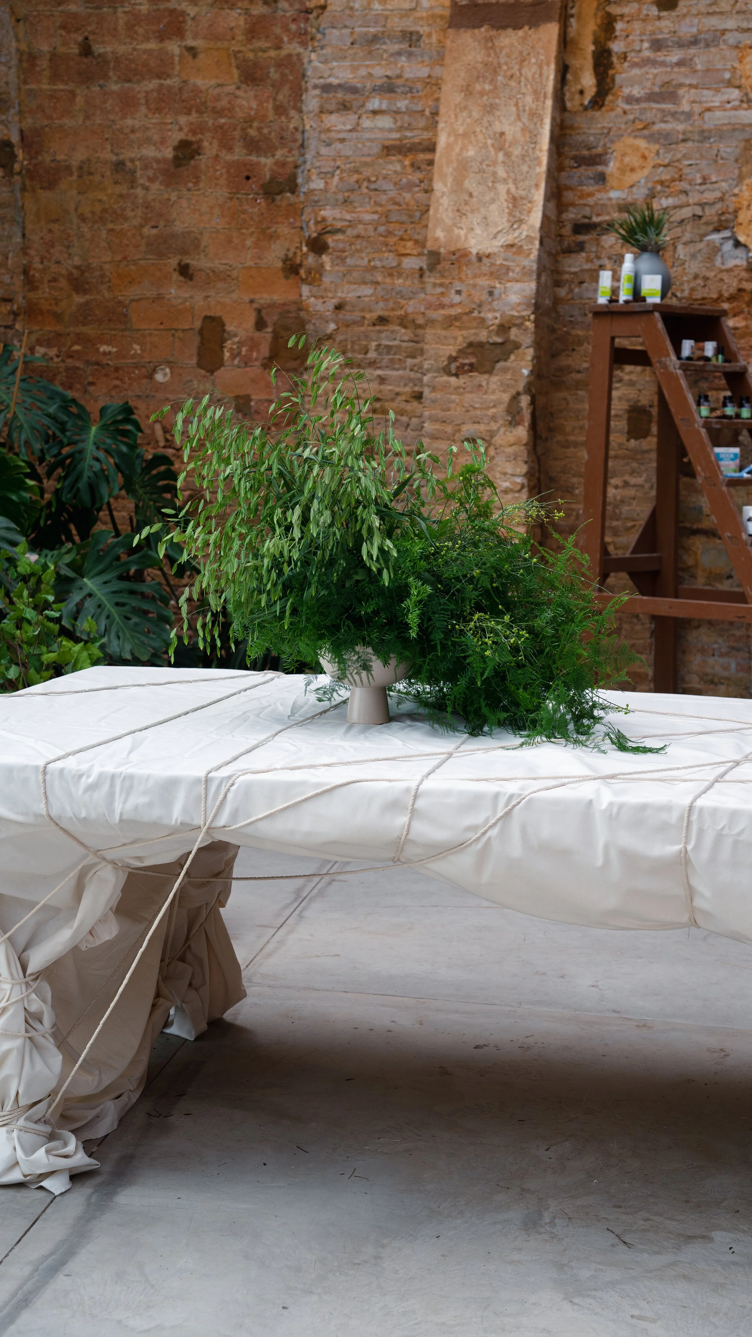 Artistic foliage arrangement combining layered textures and elegant greenery for the Pranarôm x HerbalGem luxury event organized by A Point Agency