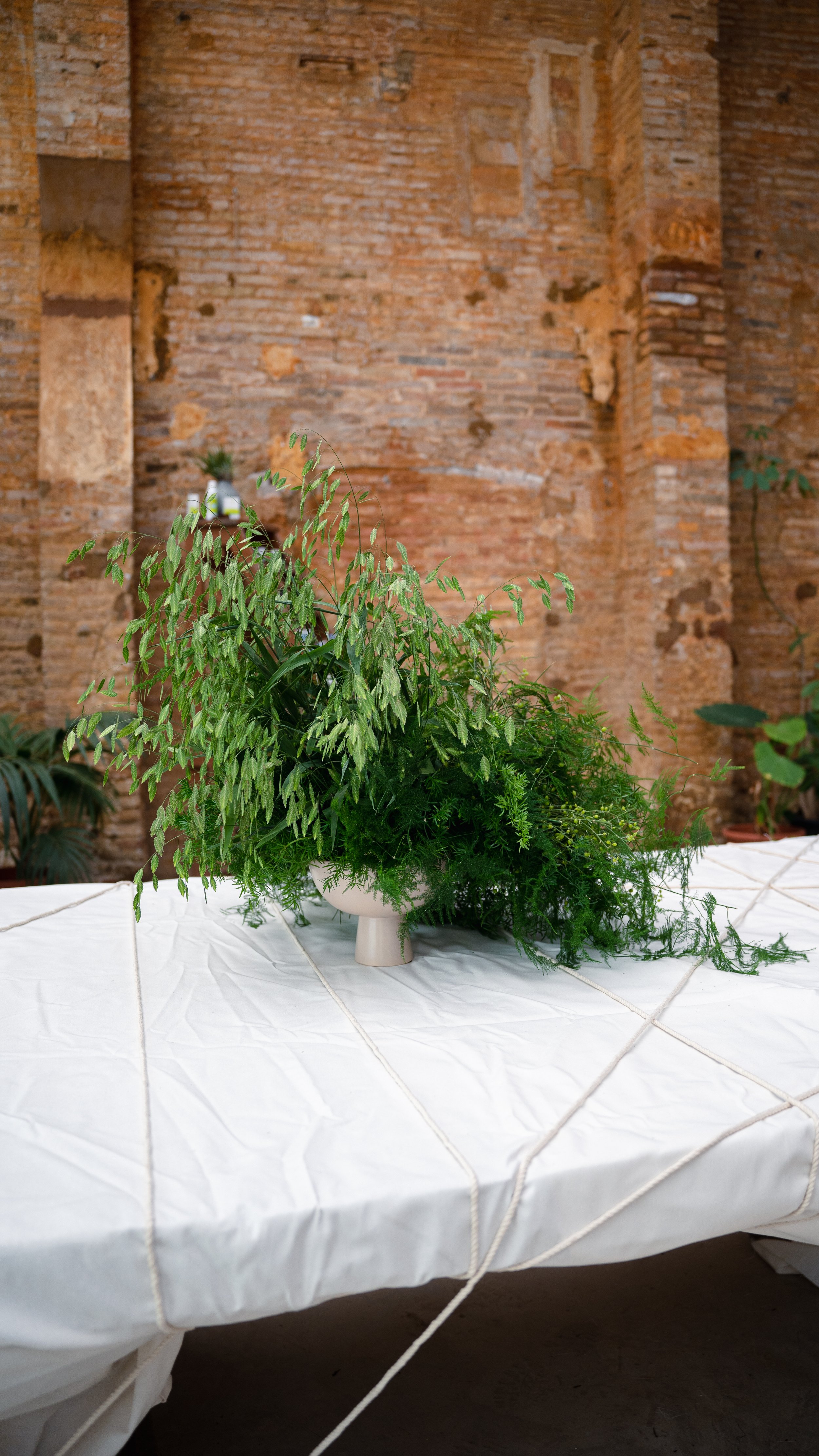 Floral designer styling a bespoke luxury foliage installation for the Pranarôm x HerbalGem event organized by A Point Agency at Flowers by Bornay