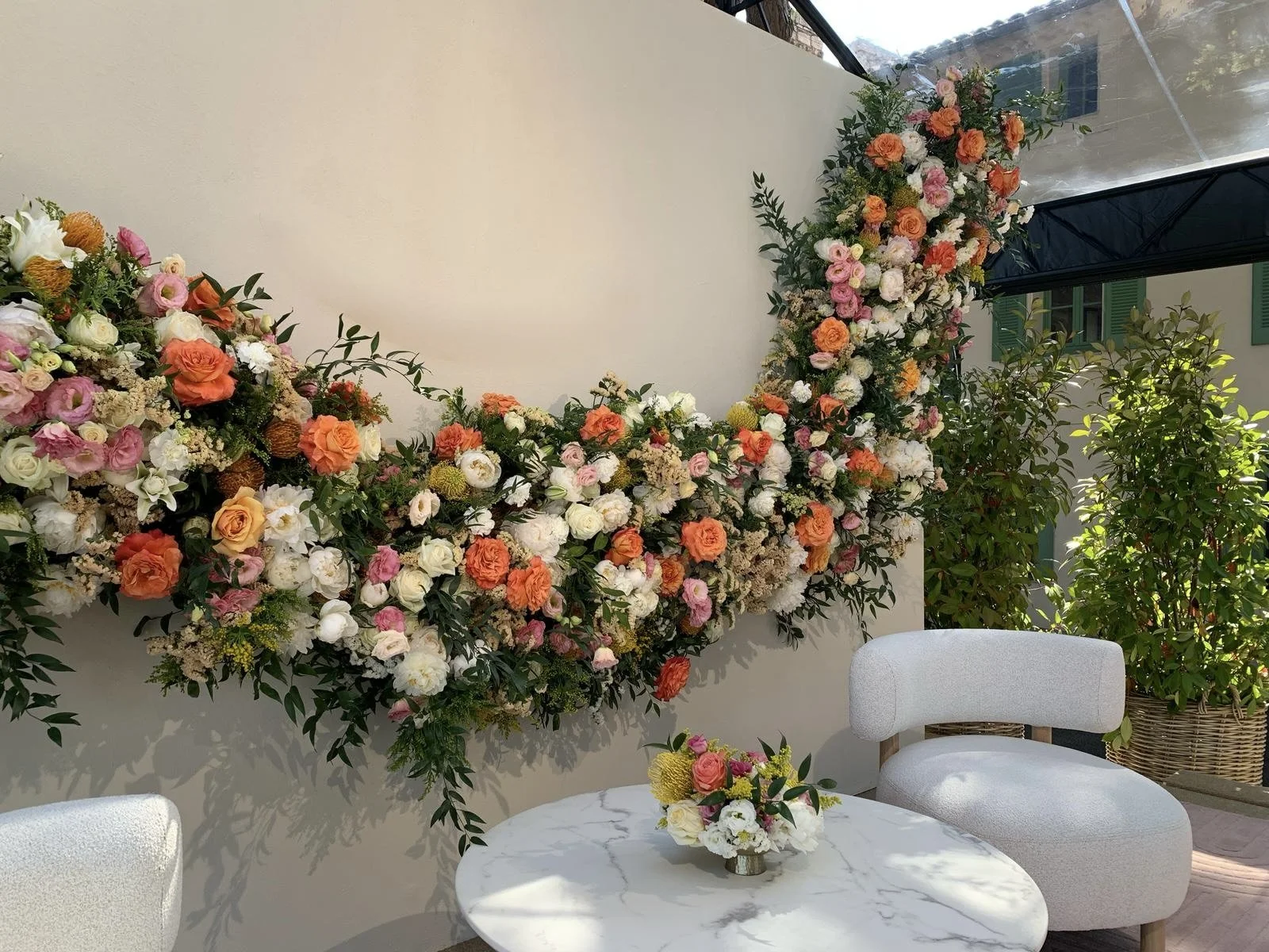 Luxury stage styling with bespoke floral arrangements by Mosaic Flowers for an international brand during Cannes Lions Festival 2025, combining elegant lounge furniture with abundant seasonal flowers