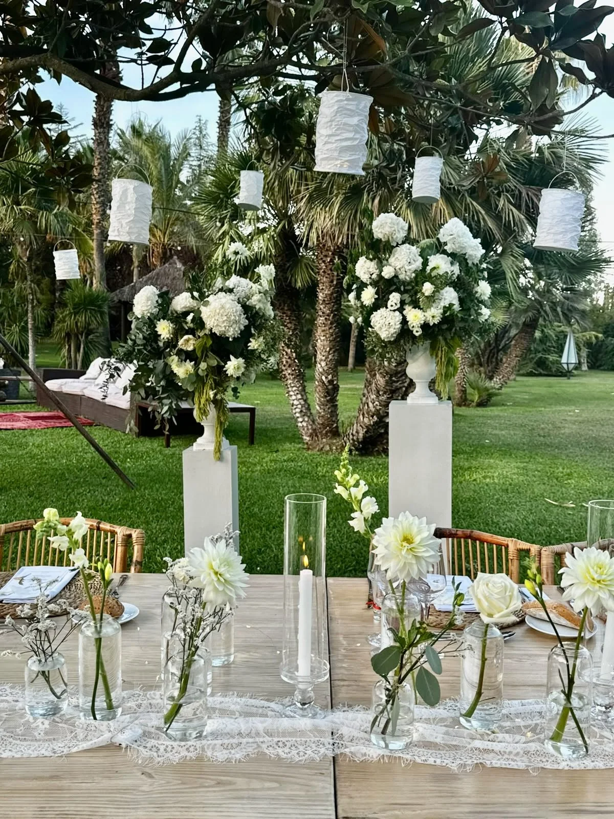 Close-up view of Mosaic’s floral and table design for Megan and Shane’s wedding at Cortal Gran, showcasing delicate white blooms, taper candles, glassware and refined natural textures
