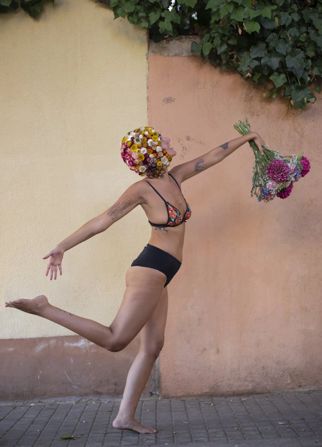 Woman dancing with floral headpiece styled by Mosaic Flowers in editorial photoshoot Barcelona