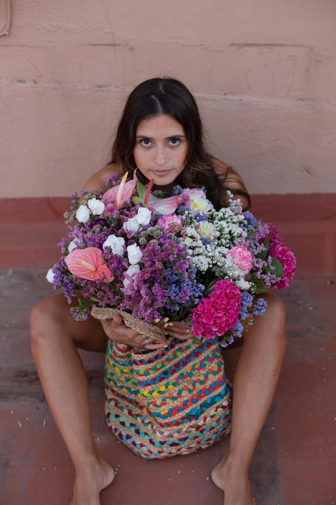 Stylish woman carrying bouquet of flowers by Mosaic Flowers in editorial photoshoot Barcelona