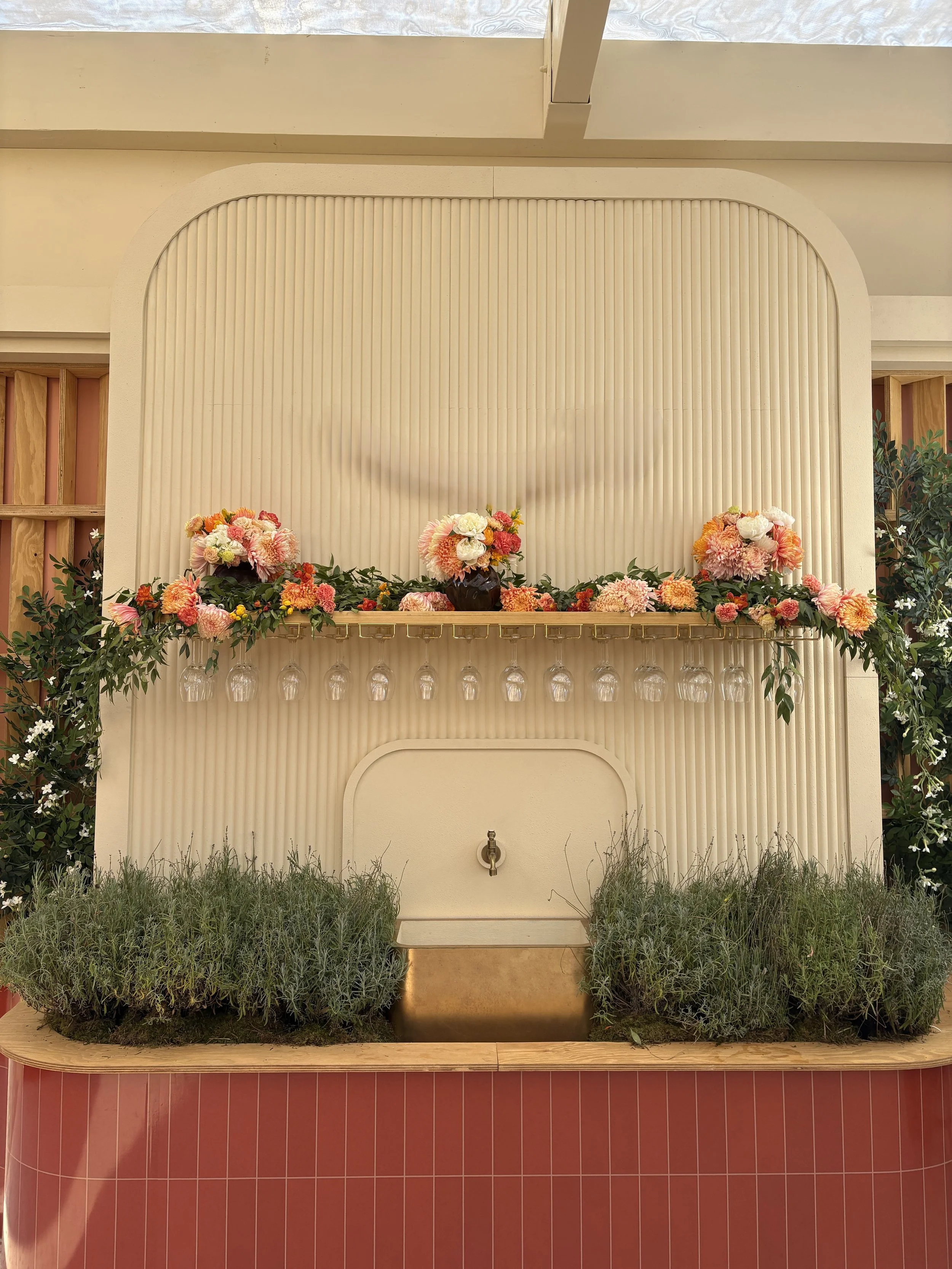 Bespoke floral installation framing a Mediterranean-inspired fountain, designed by Mosaic Flowers for a luxury brand experience during the Cannes Lions Festival