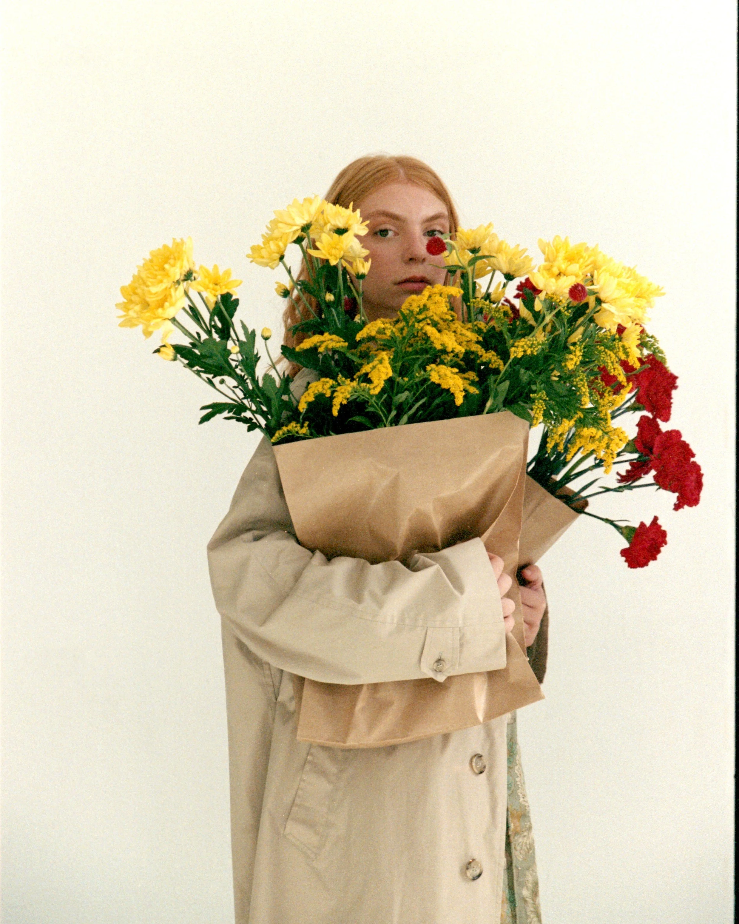 Fashion model carrying yellow and red flowers in Barcelona, styled by Mosaic for a magazine editorial shoot