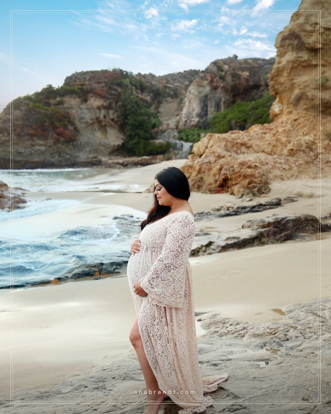 Brittany and her family met the tide at Laguna &mdash; her husband at her side, her big girl leaning in close, and one more on the way.
Lace against the rocks, bare feet in the sand, late light spilling down the coastline. A family of three holding t