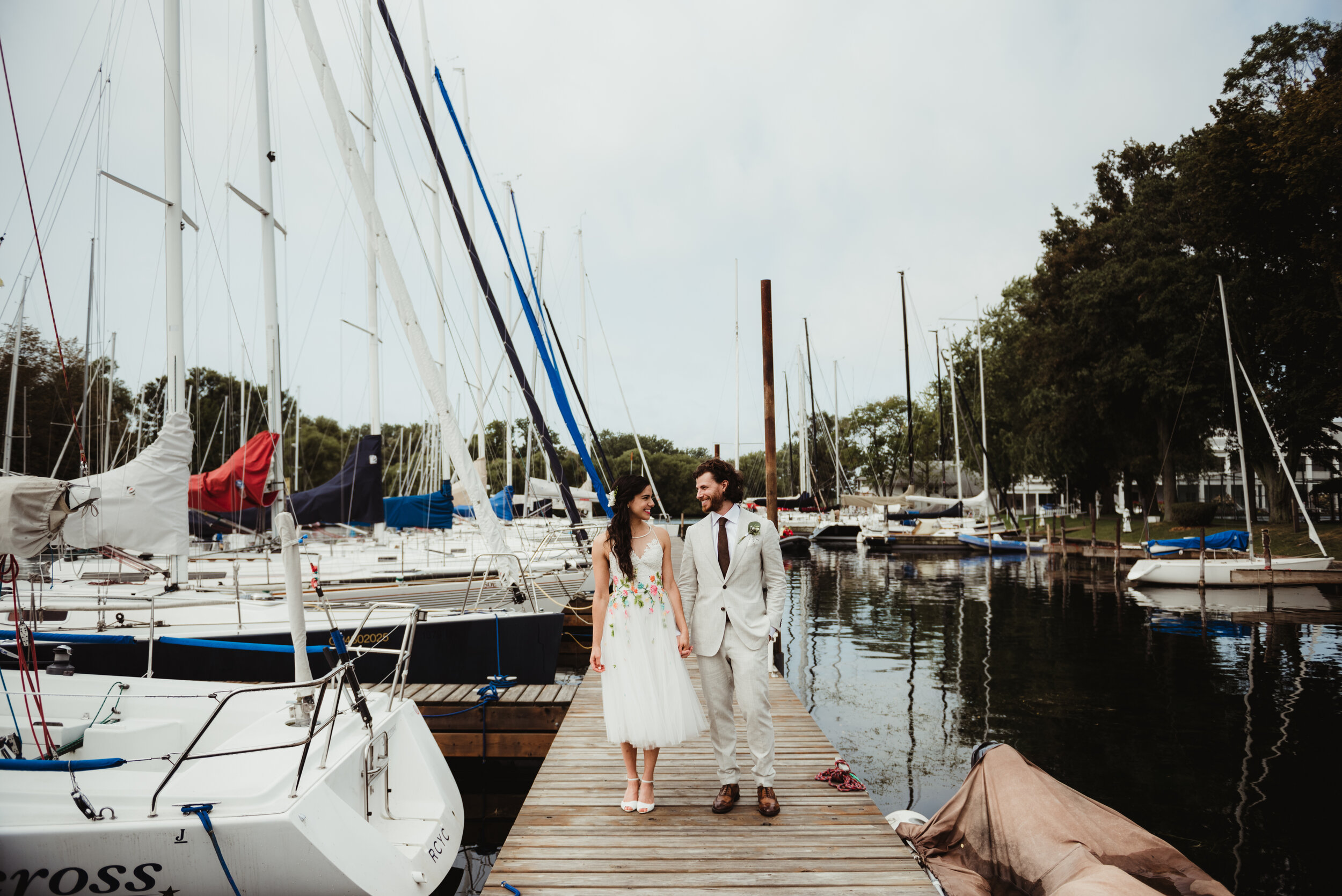 Bride and groom walking on dock
