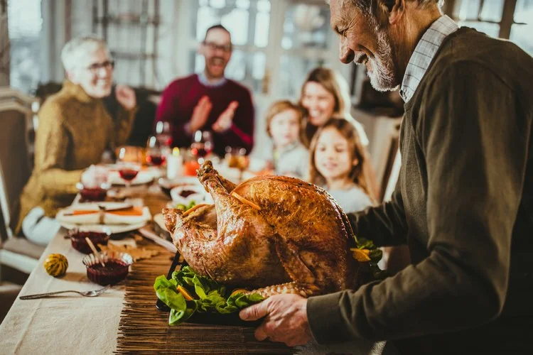 man-carrying-turkey-dinner-table.jpg