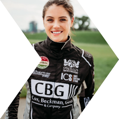 Young woman in racing suit smiling outdoors