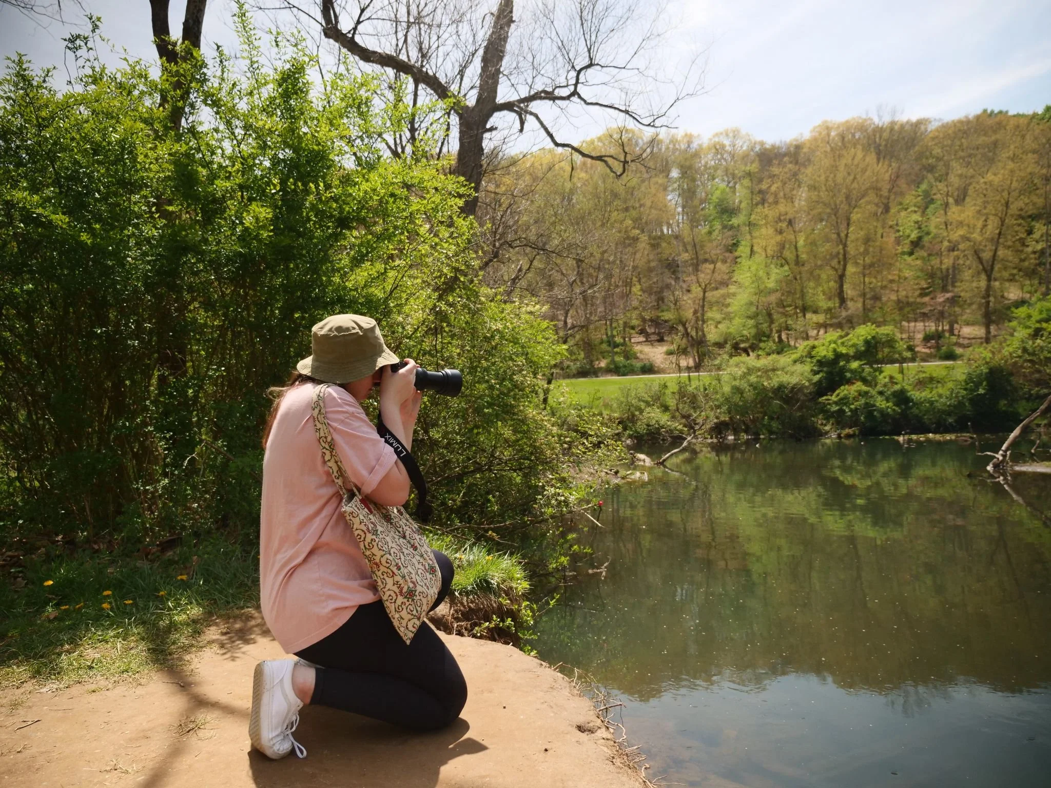 Photo of Elise taking photos by a river.