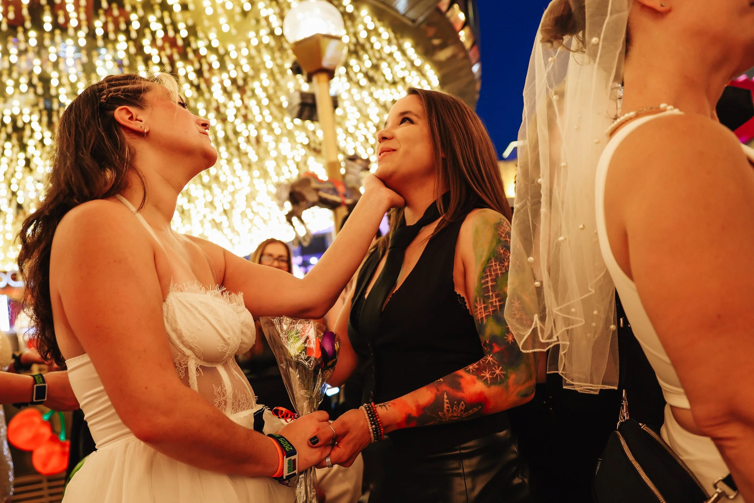 Shay Rae, left, and her derby wedding groom, Kayla Wysner, recite their vows during the RollerCon derby wedding outside of Plaza Thursday, July 10, 2025, in Las Vegas.