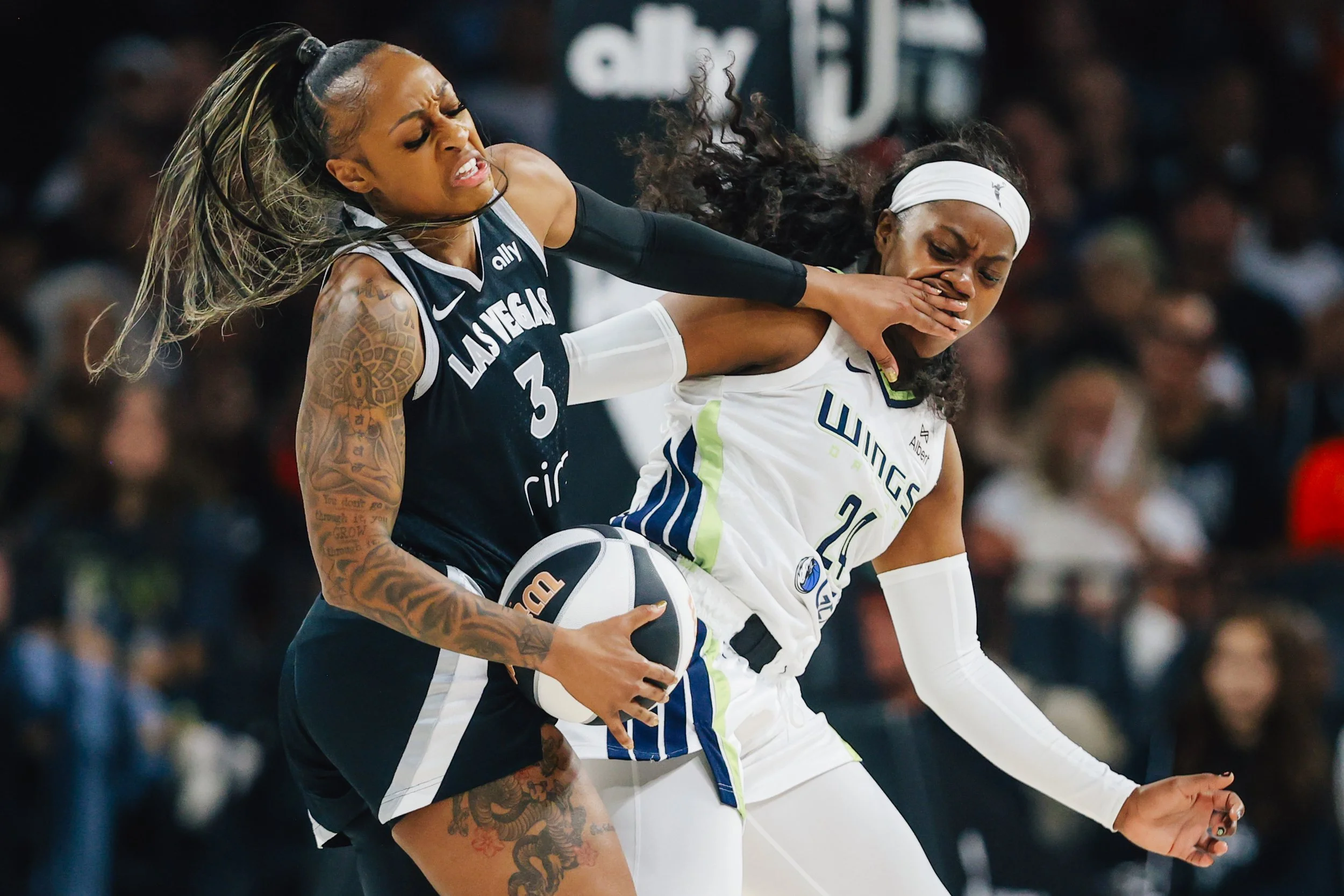 Las Vegas Aces guard Tiffany Mitchell (3) tries to keep away from Dallas Wings guard Arike Ogunbowale (24) during a WNBA basketball game between the Aces and Dallas Wings at Michelob ULTRA Arena Friday, June 13, 2025, in Las Vegas.