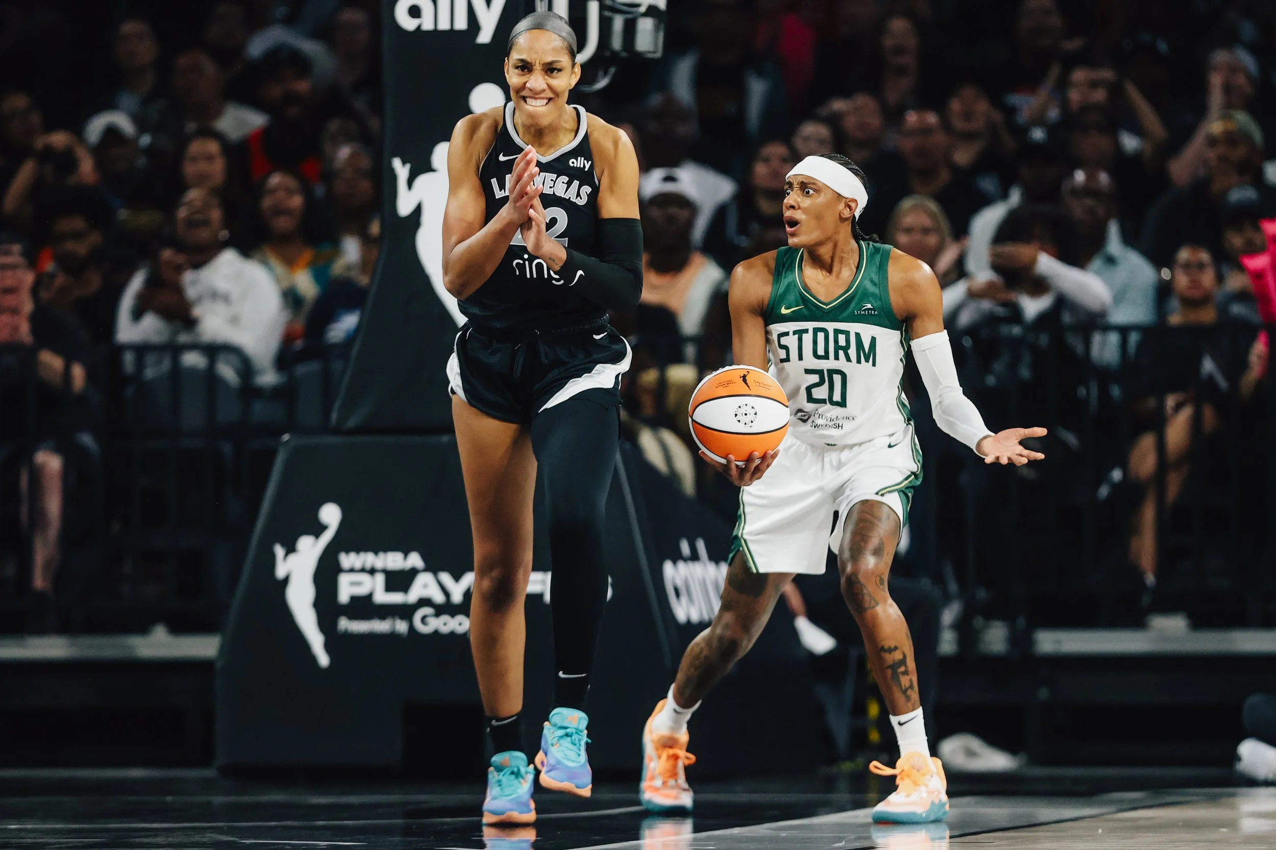 Aces center A'ja Wilson (22) celebrates as Seattle Storm guard Brittney Sykes (20) reacts to a call by a referee that turned the ball over to the Aces during game three of a first round WNBA playoff basketball game between the Aces and Seattle Storm 