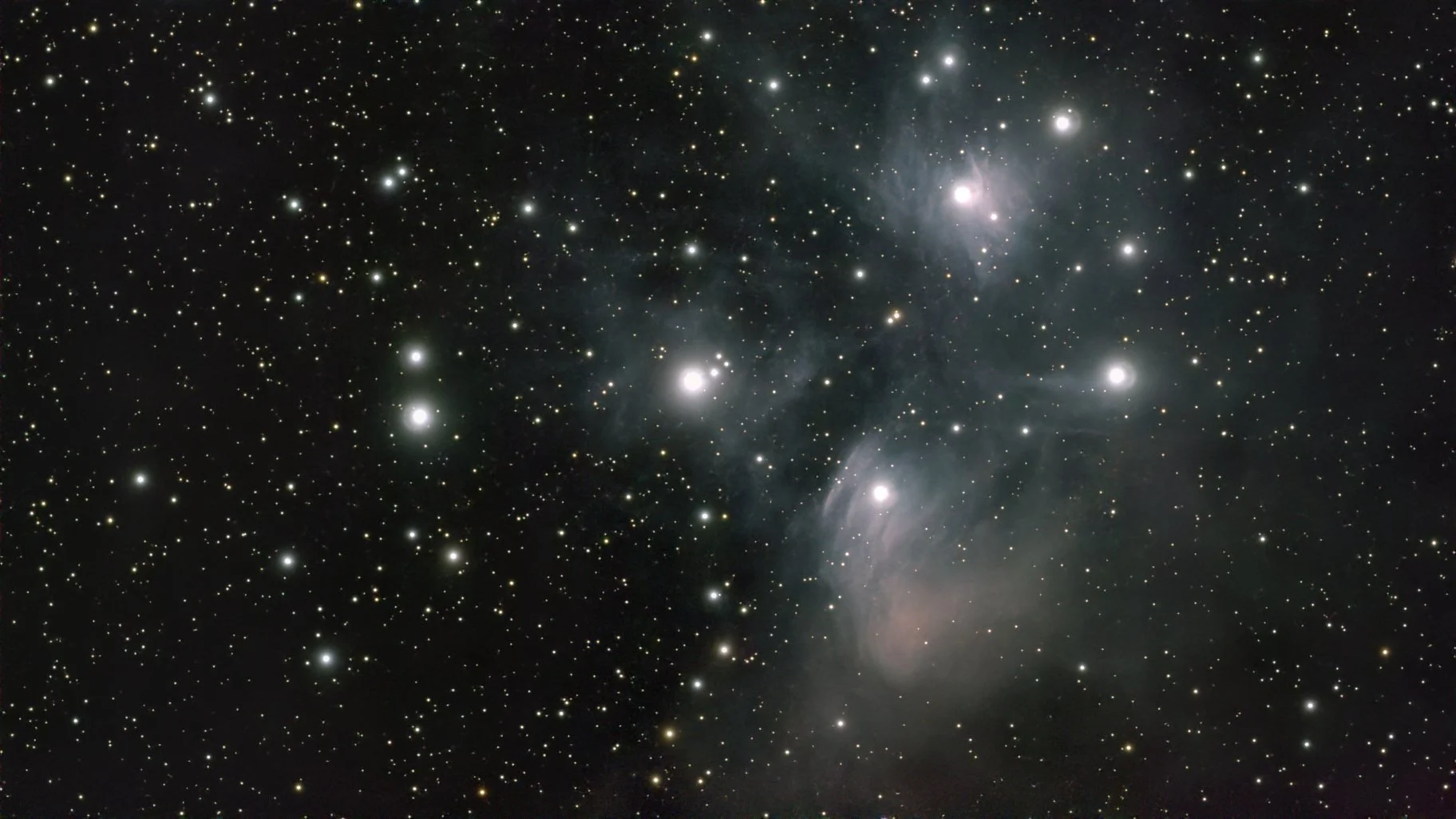 A vibrant deep space view of stars, nebulae, and cosmic dust against a dark background.