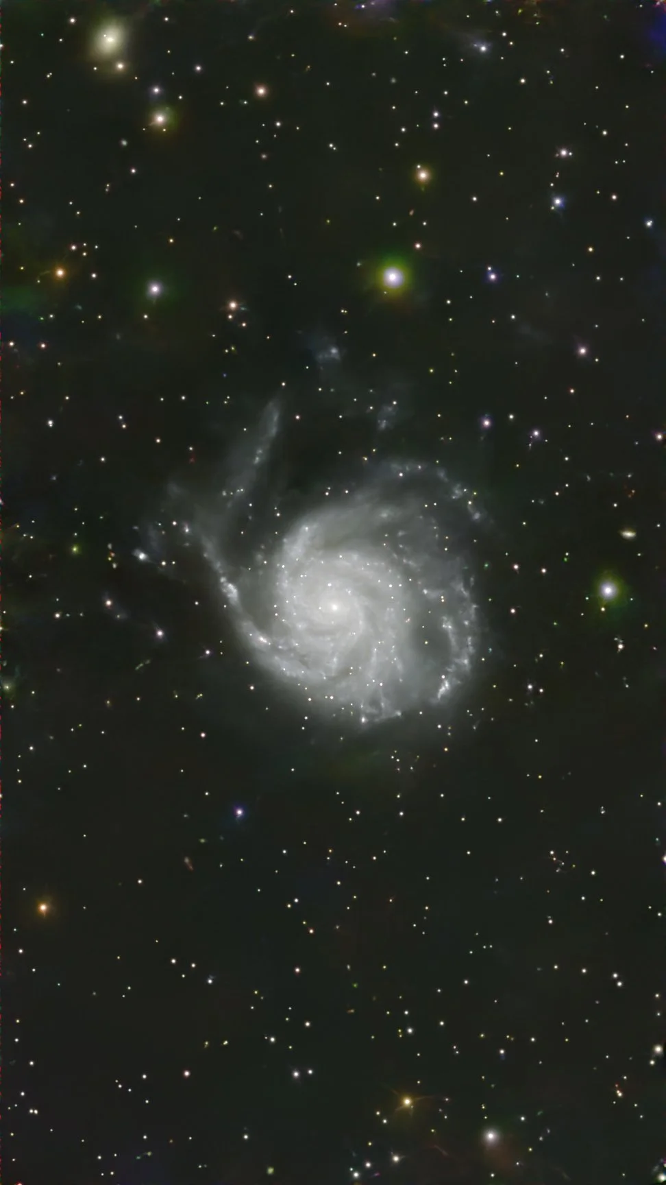 A spiral galaxy with numerous stars and cosmic clouds against a black space background.