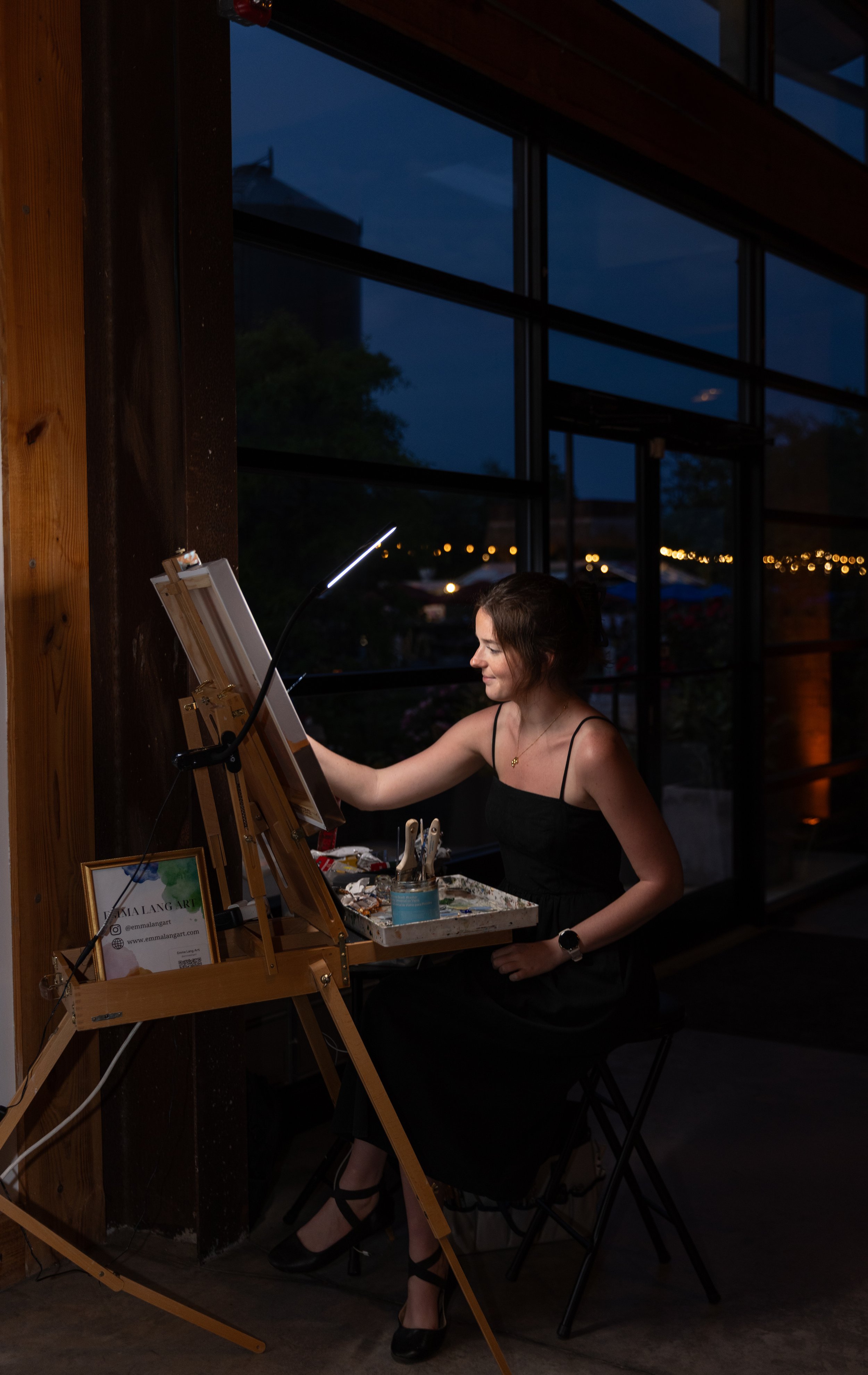 Emma Lang is painting at the Porter Room a live wedding painting of the bride and groom.