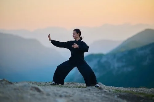 person practicing qigong slow energy movement meditation outdoors - Great Energy Qigong