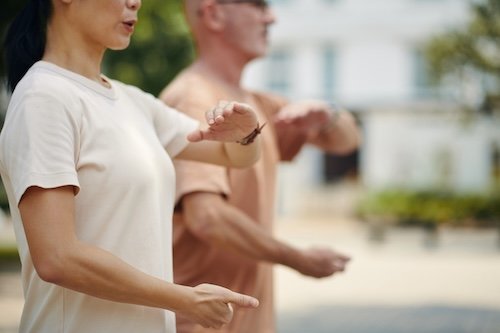 person practicing qigong slow movement breathing meditation