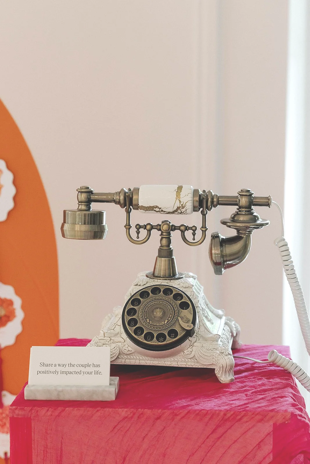 A white and brushed gold audio guestbook phone and wedding prompt cards set up at a Sandy River Garden wedding reception.