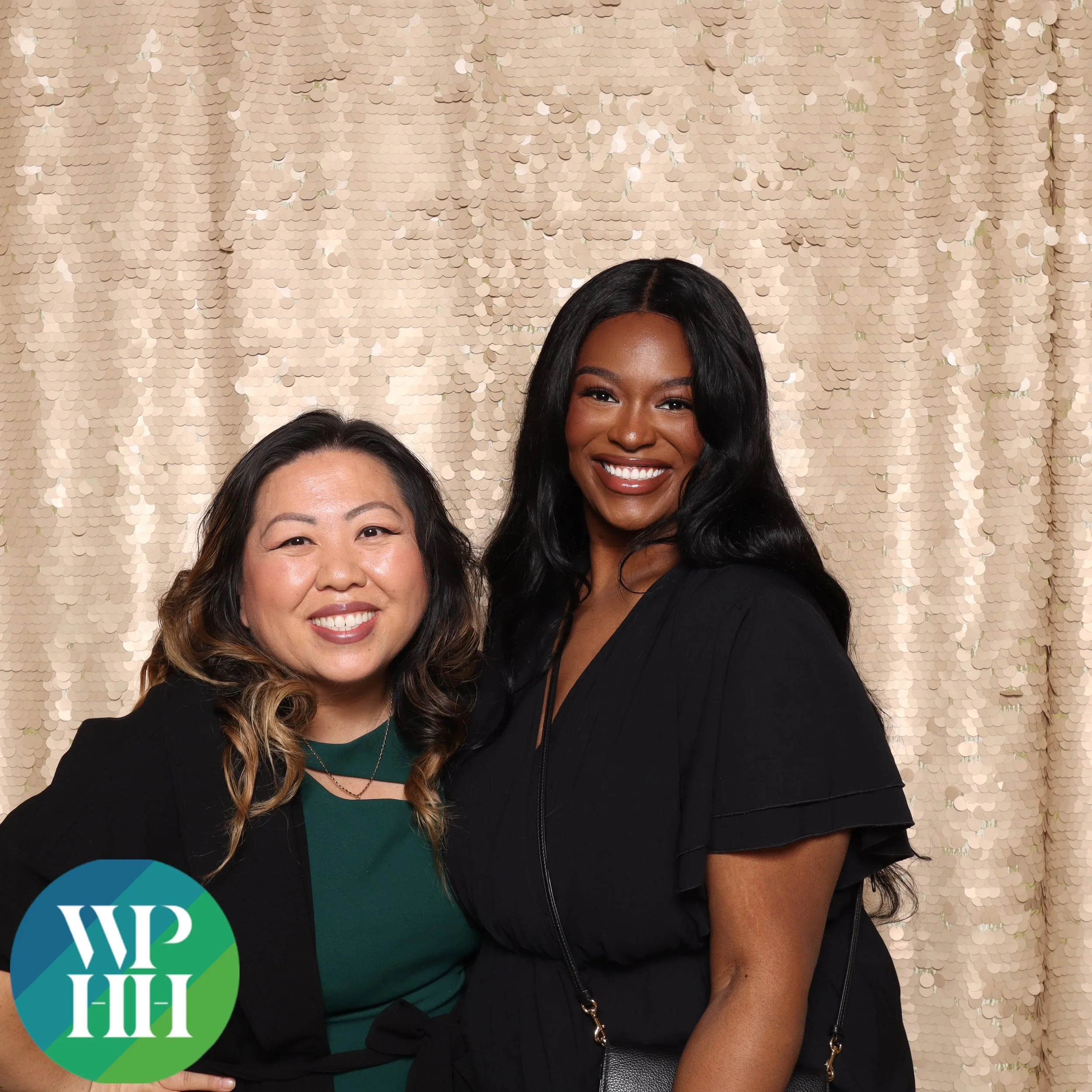 Coworkers posing at a Portland networking-event photo booth with a gold sequin backdrop
