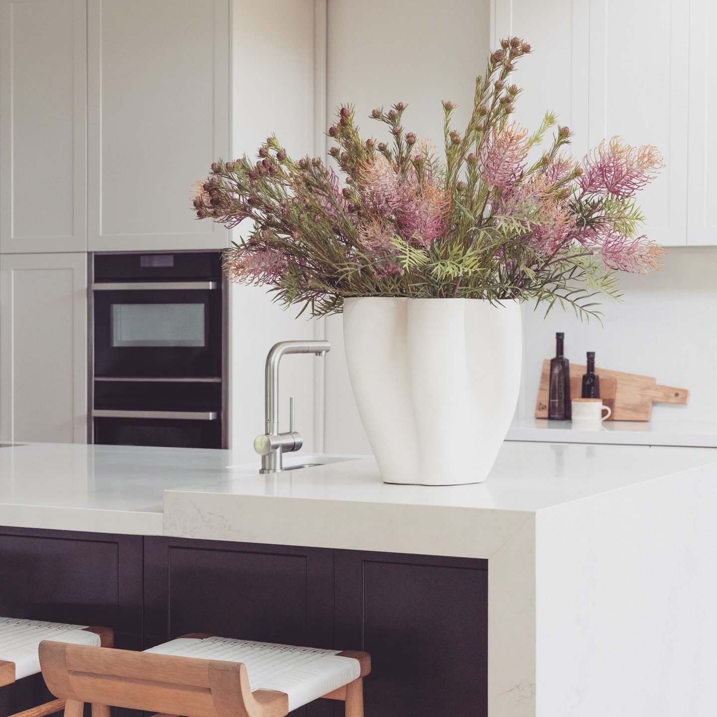 We could not resist placing this beautiful sculptural vase on this kitchen counter with the most gorgeous arrangement of indigenous flowers.