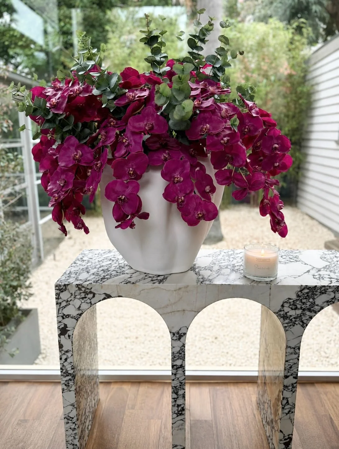 WAVE

The arches create moment of drama. 

Sculptural form, rich veining, and a cascade of deep magenta orchids creating just enough contrast.

We love pieces that feel like art in their own right&mdash;
functional, but never ordinary.

Setting the t