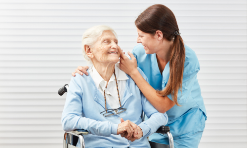 Nurse Taking Care of Senior Woman in Wheelchair