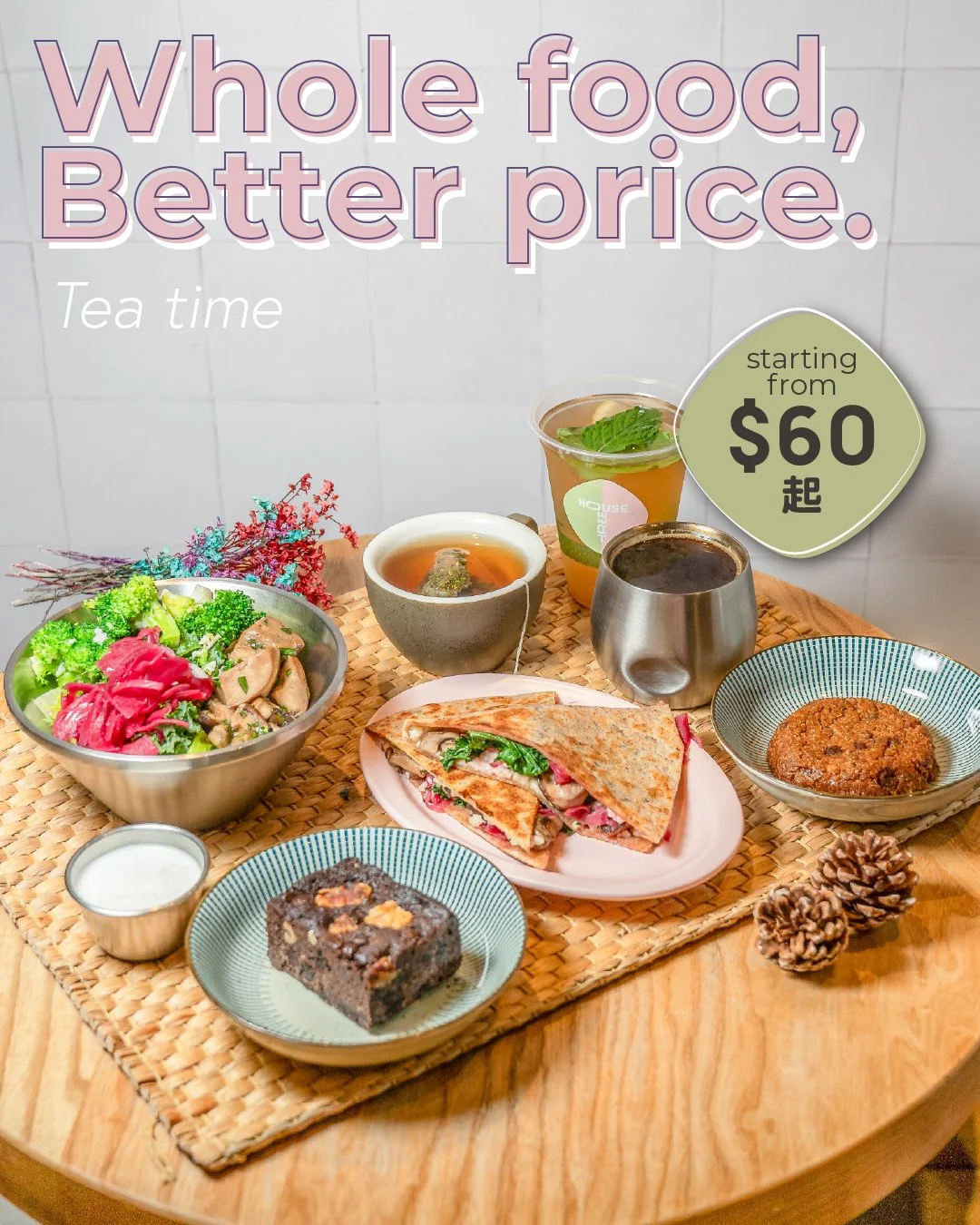 A Mediterranean platter with pita bread, falafel, spring lettuce, roasted red peppers, olives, hummus, eggplant dip, pickled vegetables, and a dipping sauce in a small cup, arranged on a round white plate on a woven placemat.