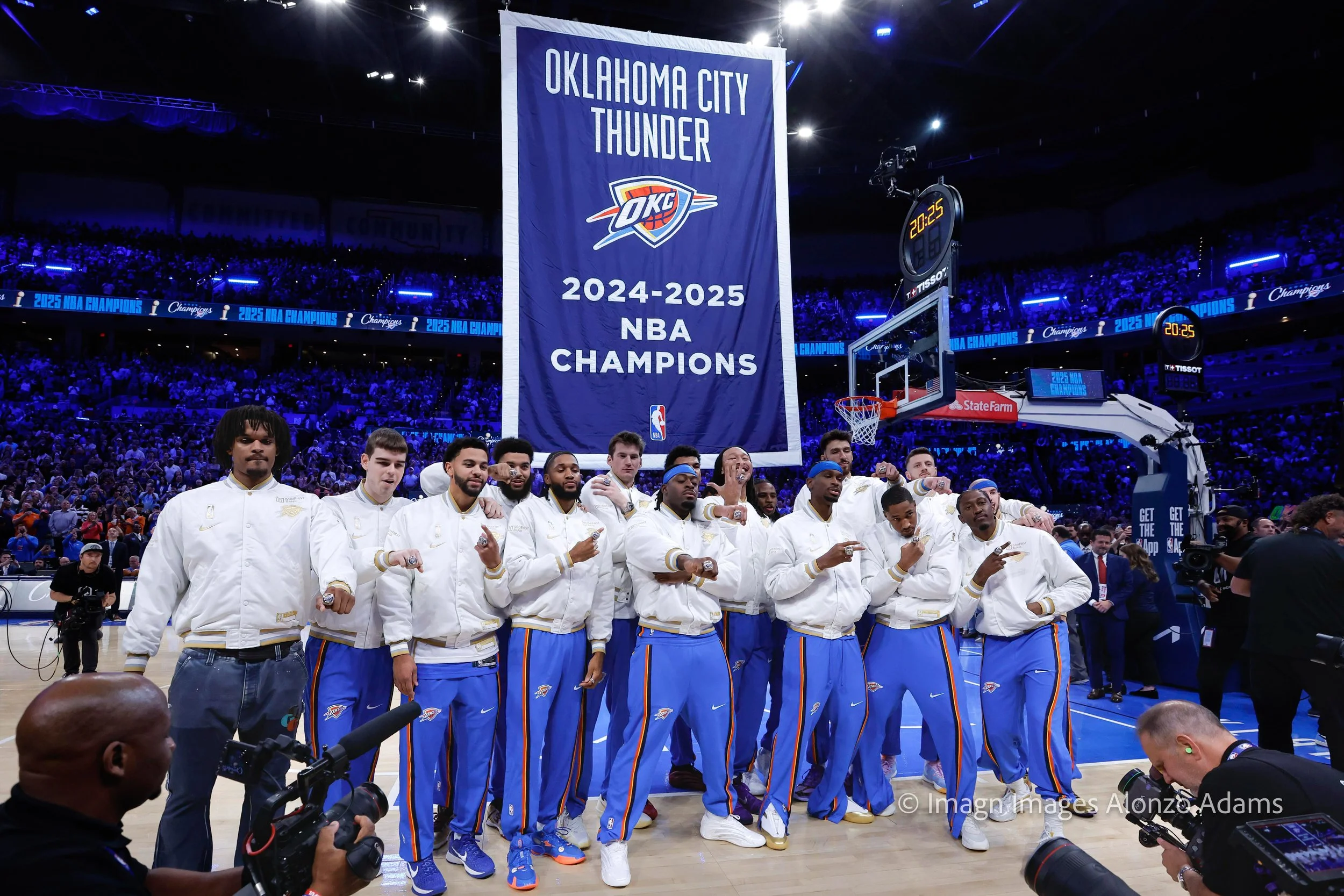 Oklahoma City Thunder poses for a photos under their 2024-2025 NBA Championship Banner