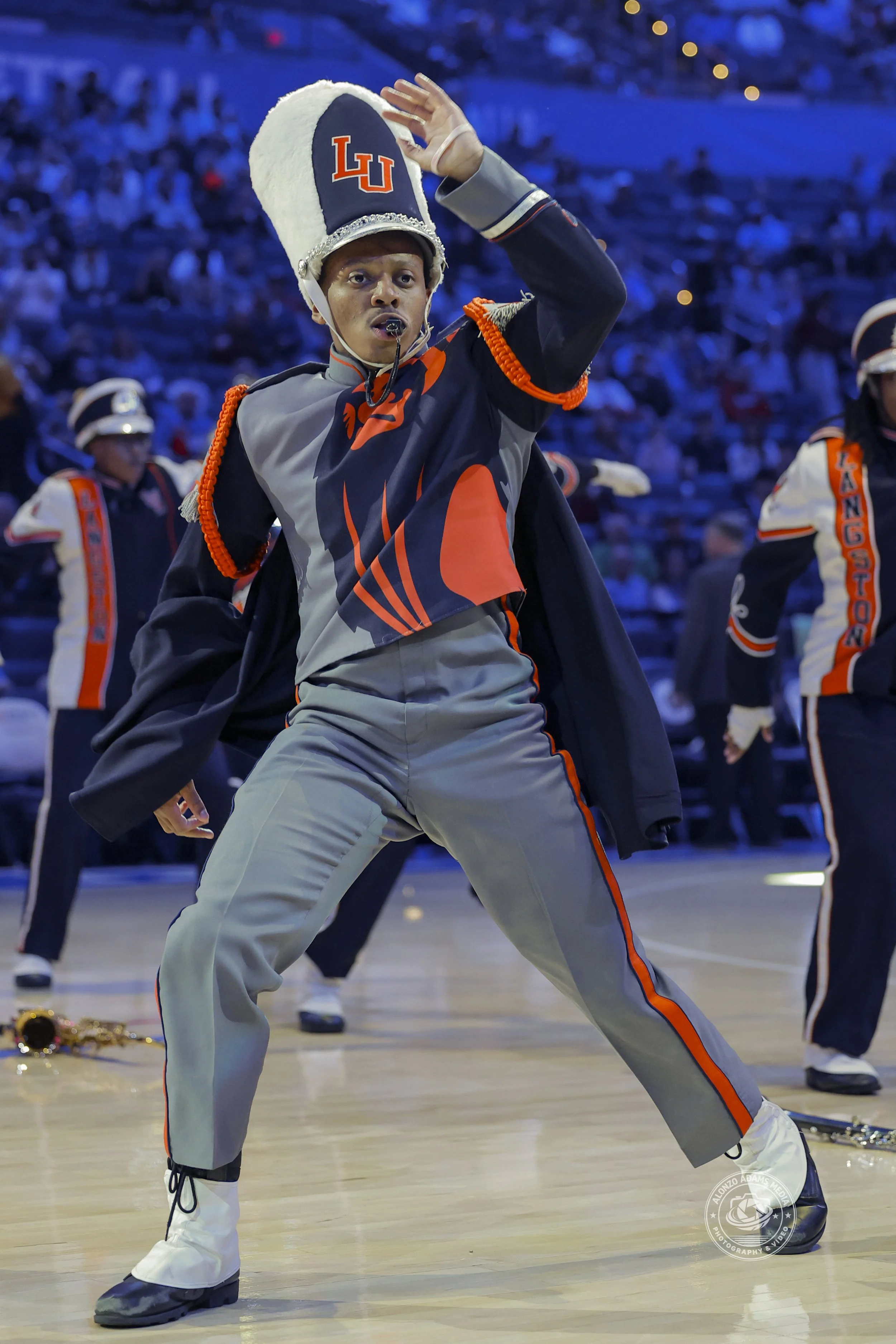 Langston University drum major wearing the uniform that is gray and orange