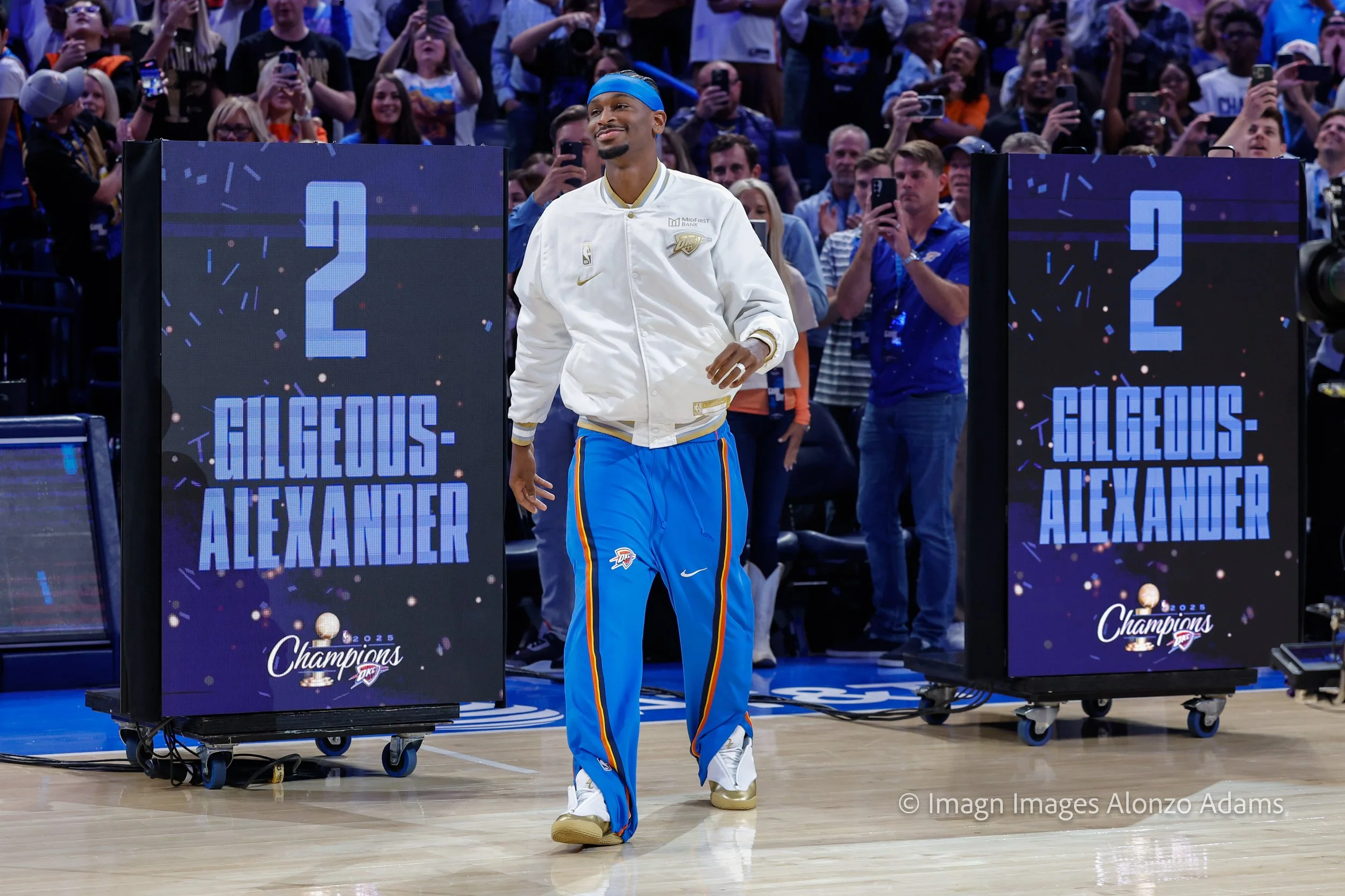 Oklahoma City Thunder's Shai Gilgeous Alexander walks onto the court for the NBA Championship ring ceremony.