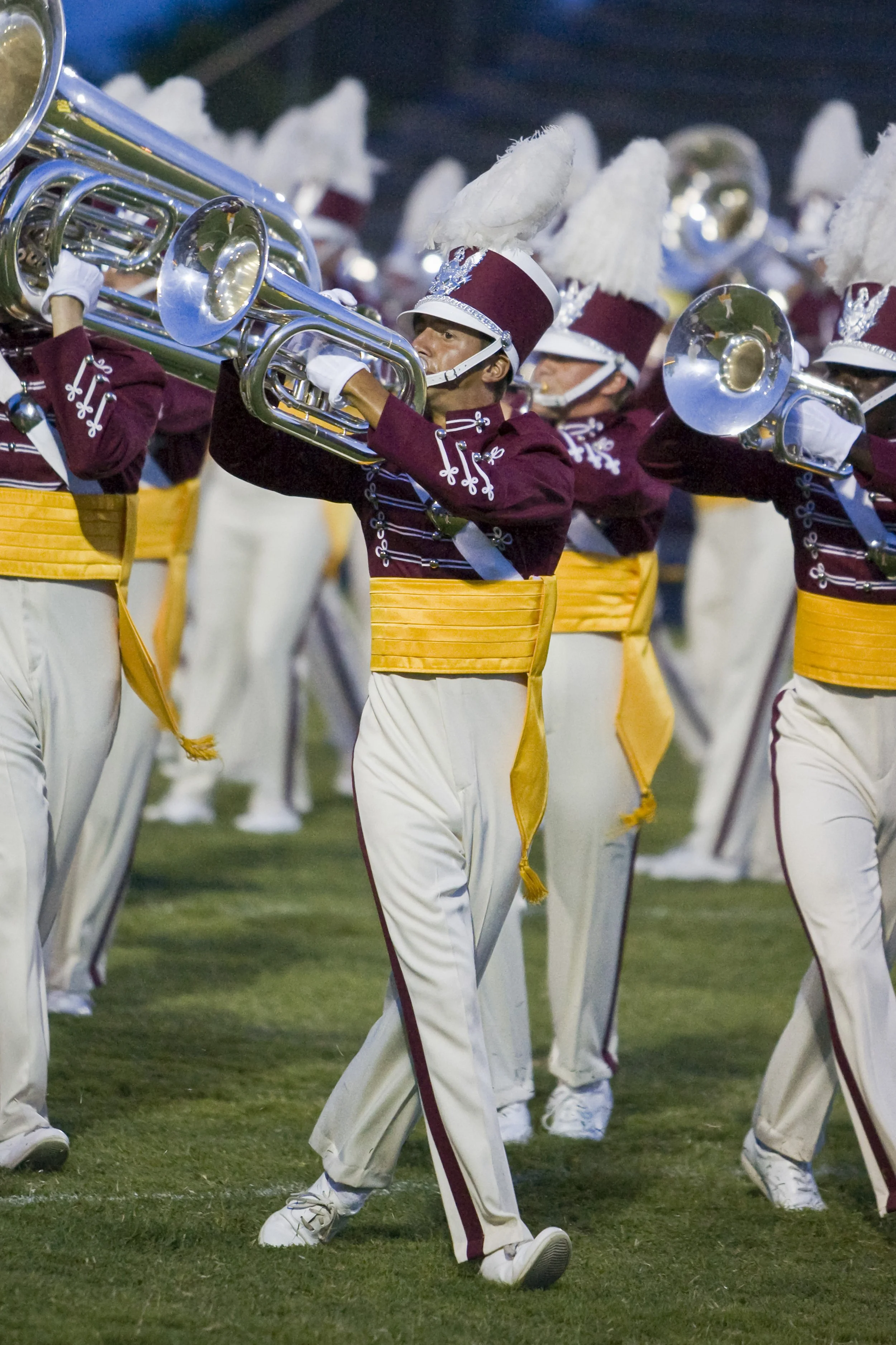 Cadets Drum and Bugle Corps baritone player in full uniform marching with horn up