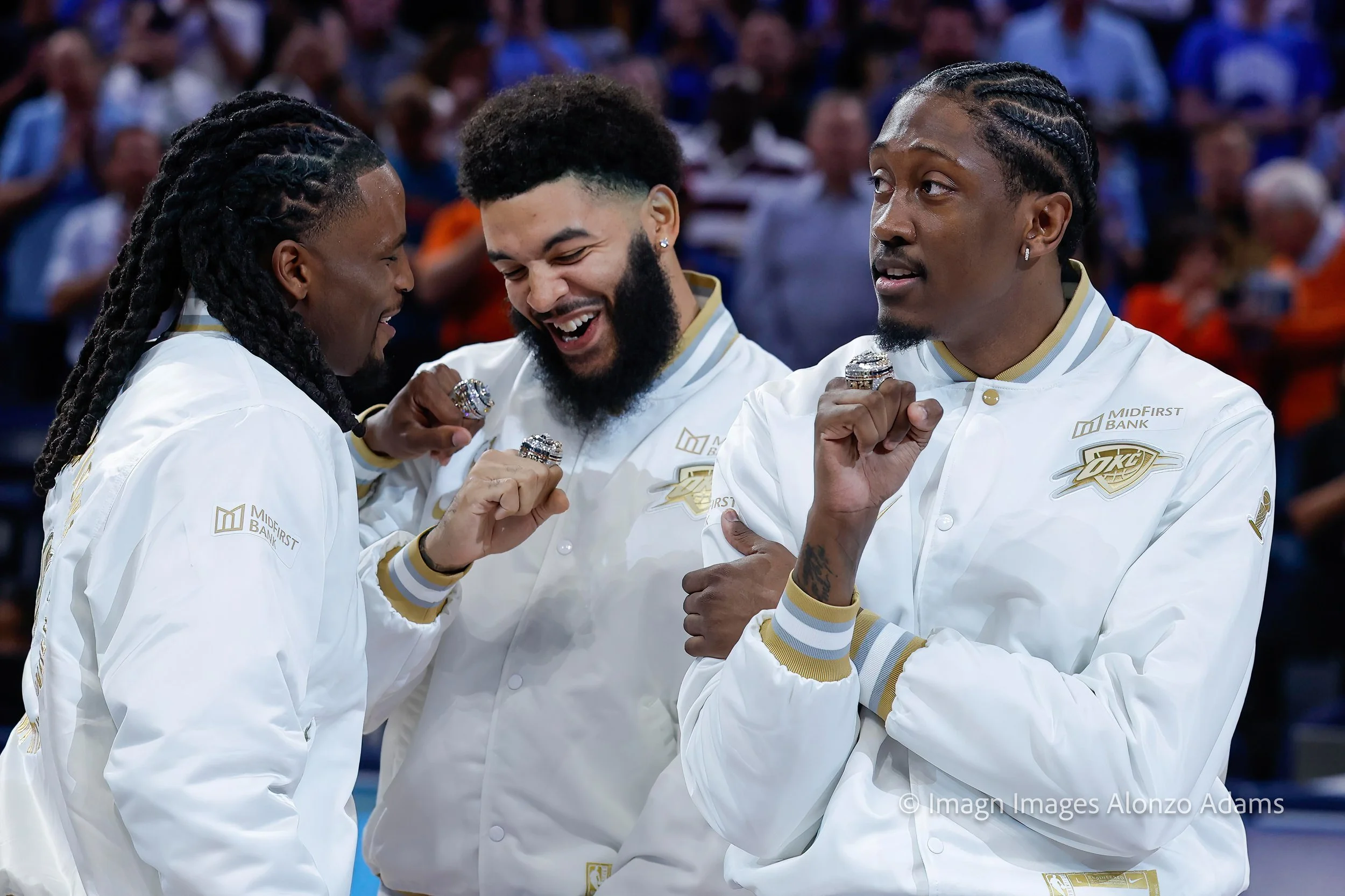 Oklahoma City Thunder players look at their 2024-2025 NBA Championship rings.