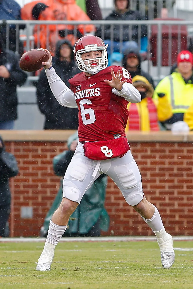 Oklahoma Sooners Football Quarterback passing in the rain.