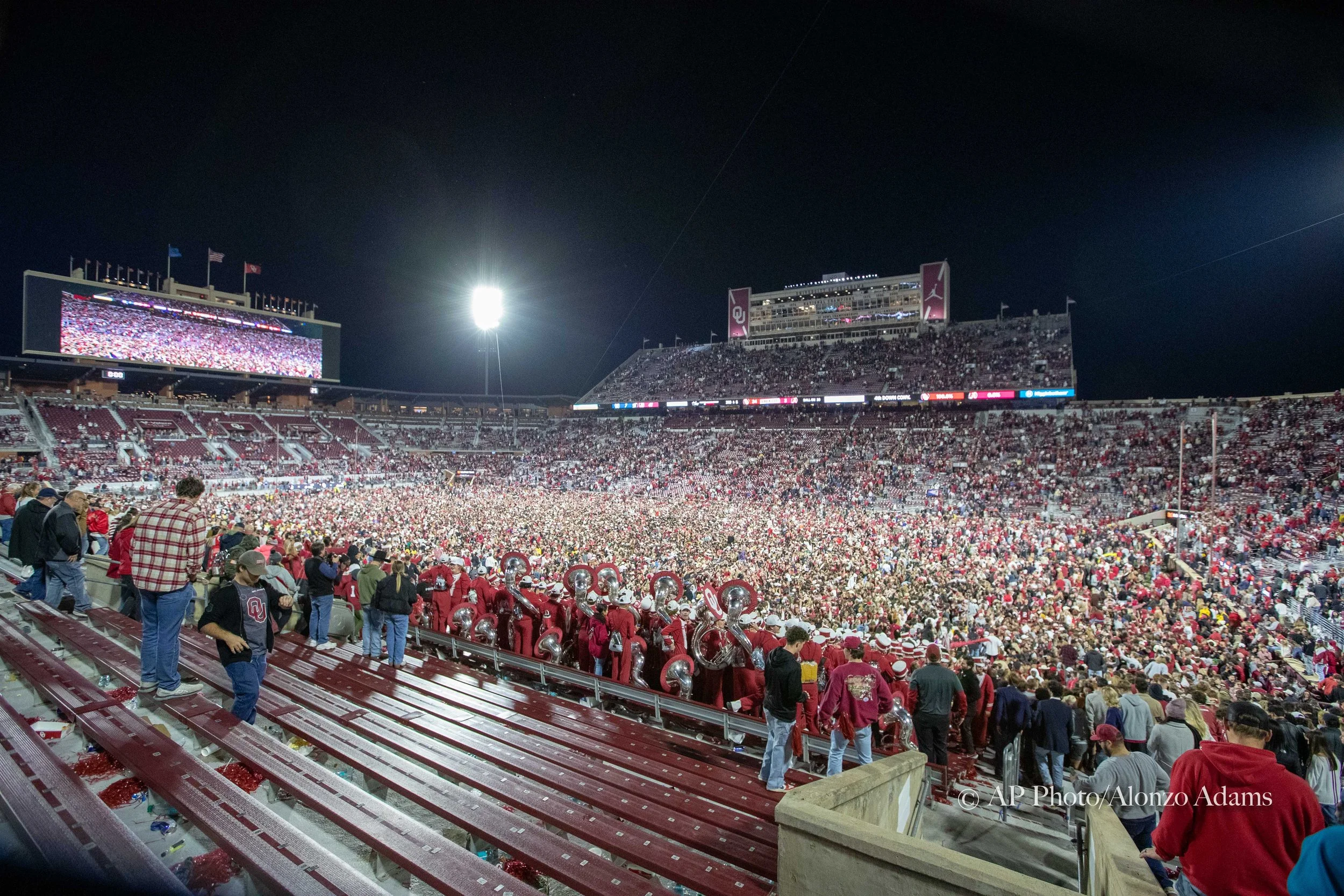 Oklahoma Sooners football fans rush the field after defeating Alabama