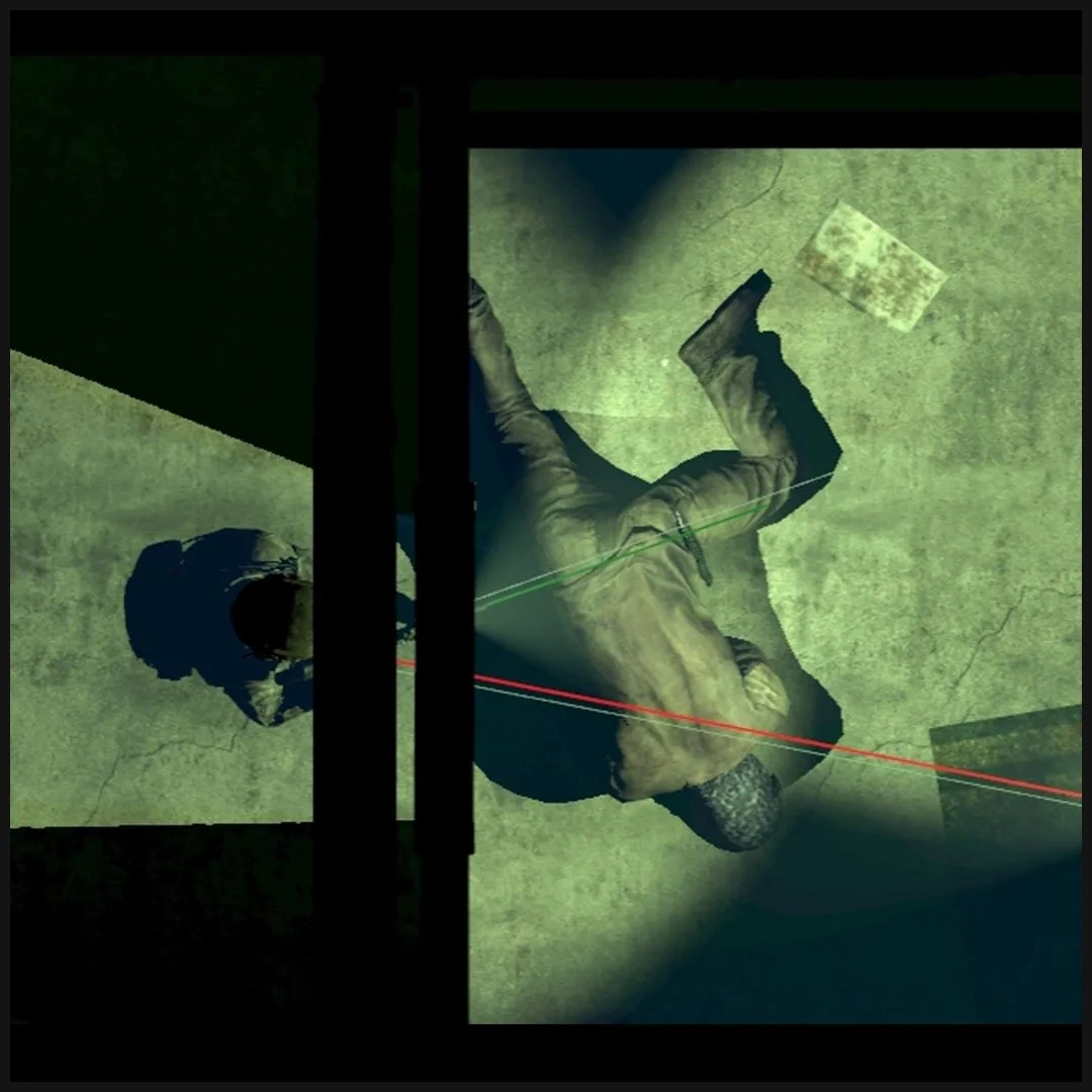 Overhead view of a scene with a person lying on the ground, illuminated by spotlights, with colorful laser lines crossing the area.