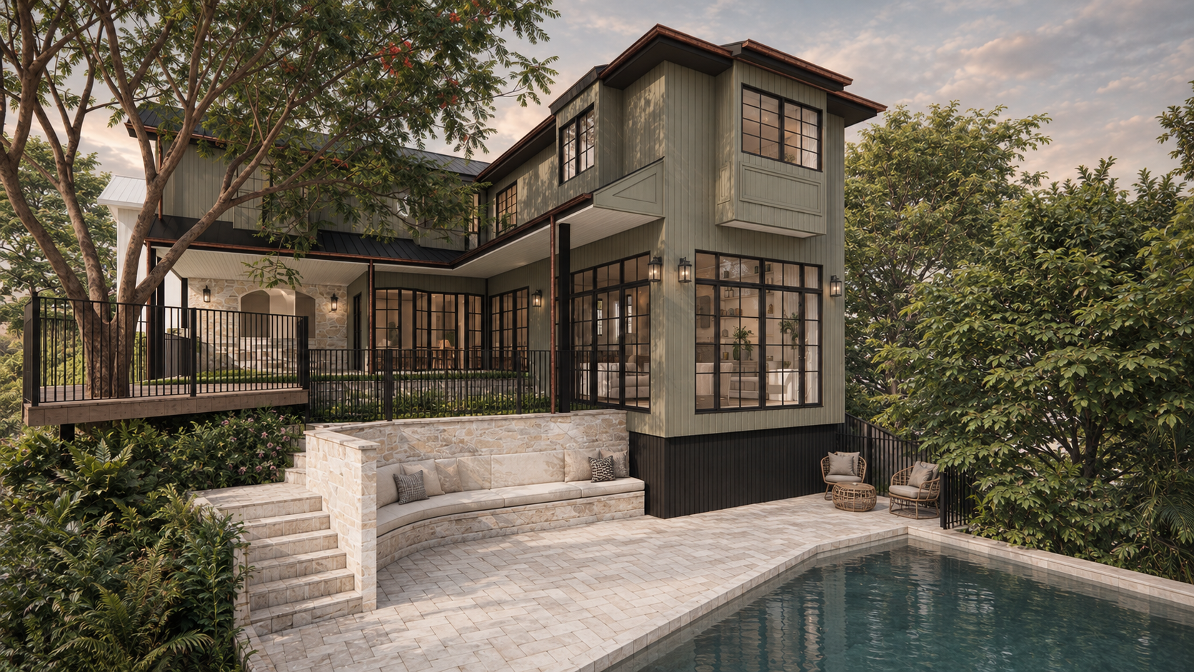A modern two-story house with large glass windows, a stone patio, a swimming pool, and surrounding green trees at sunset.